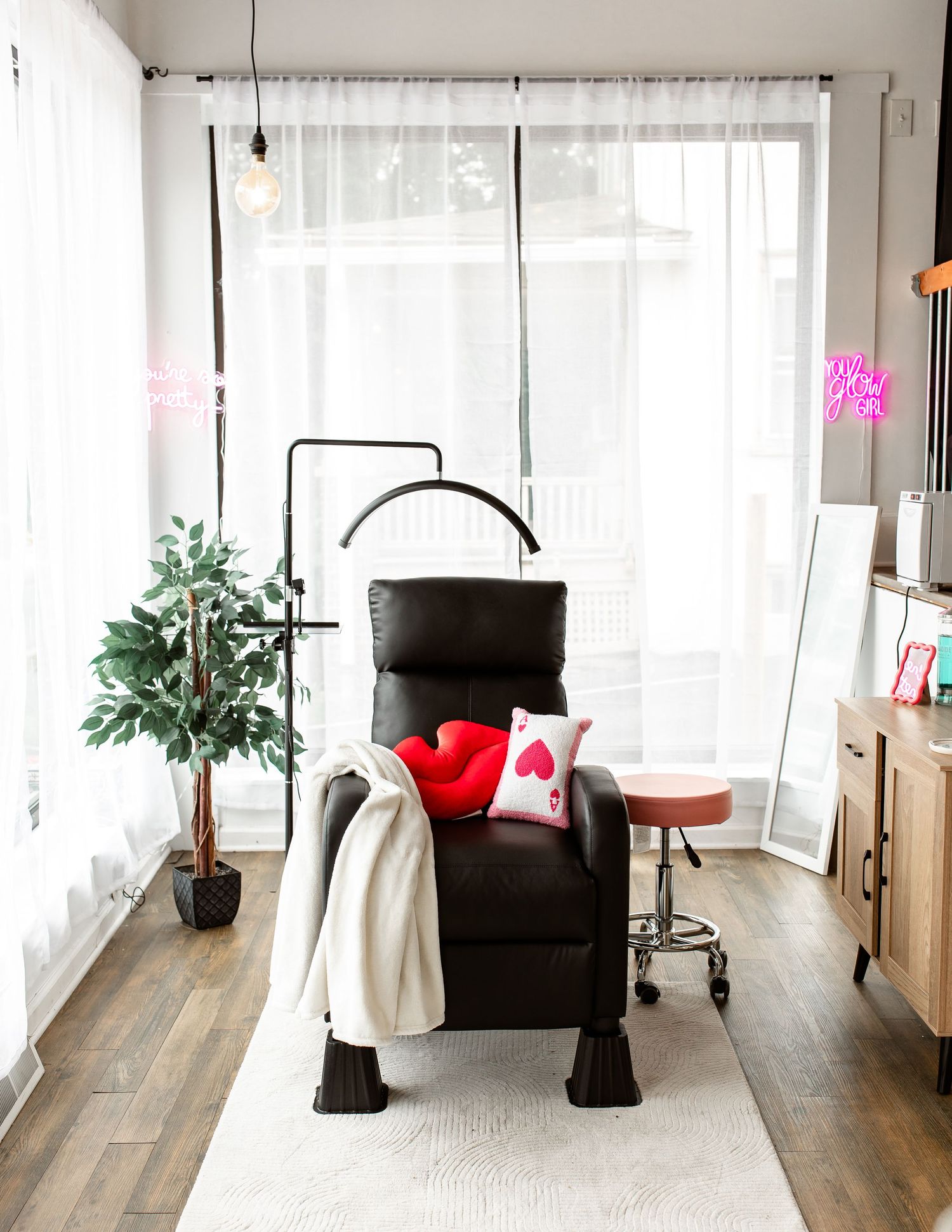 Modern minimalist home office space with wooden floors and white curtains.