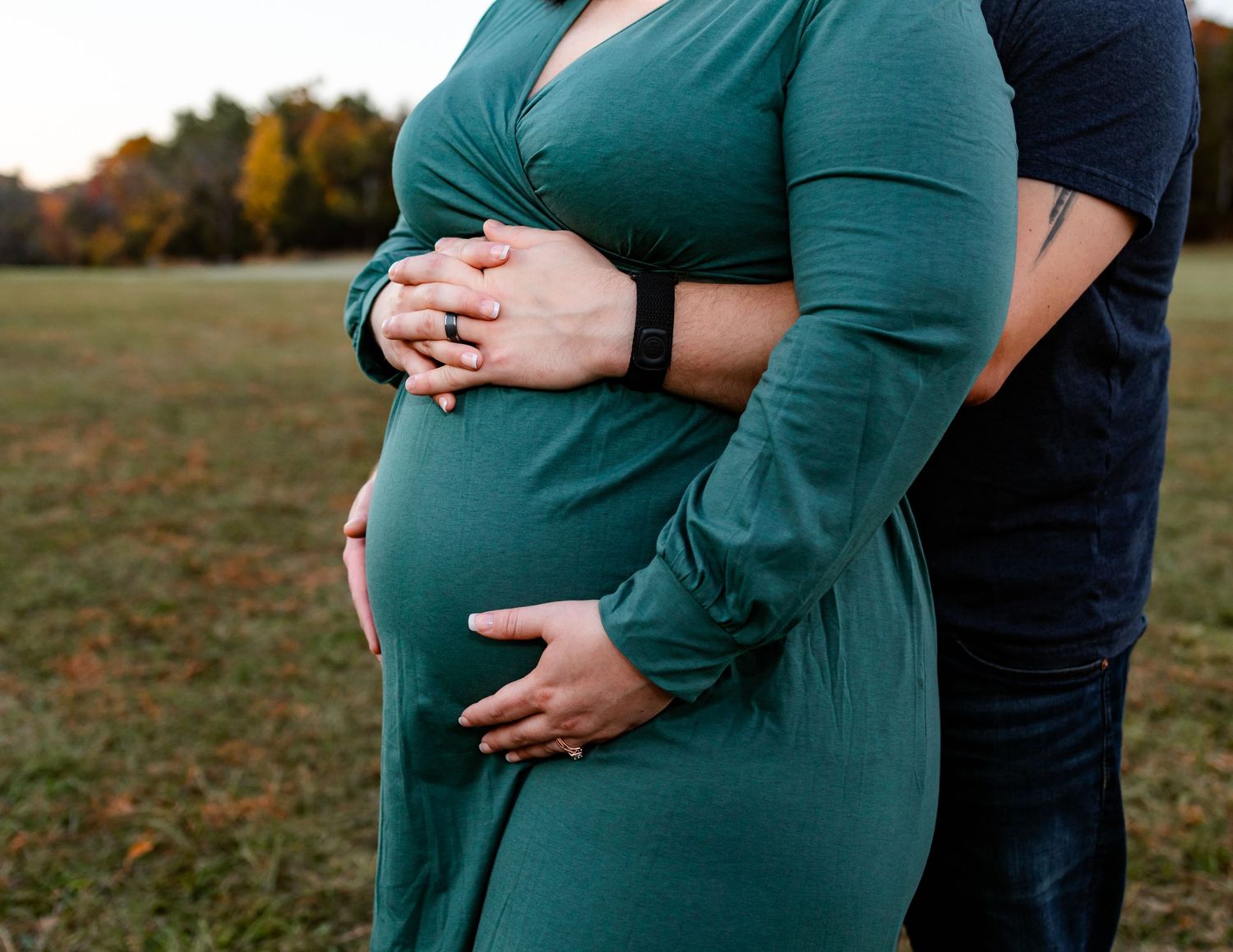 Close-up maternity poses showing tender moments between expectant couple outdoors.