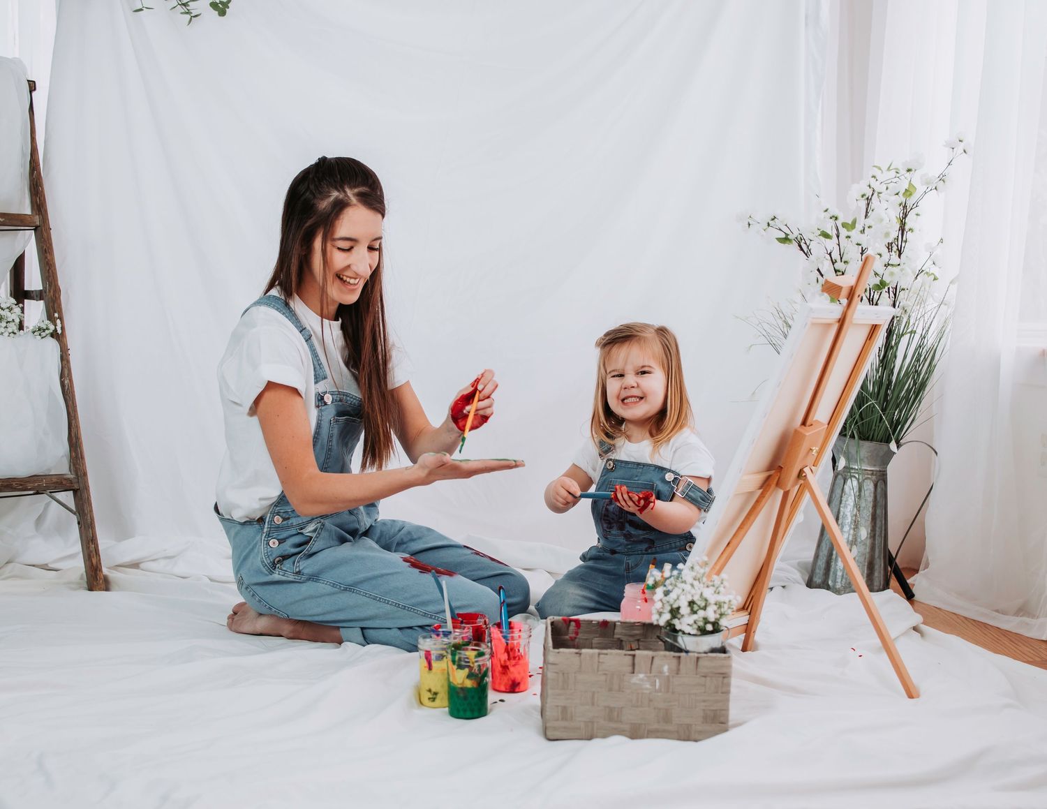 Fun painting session with bright colors and art supplies on white backdrop.