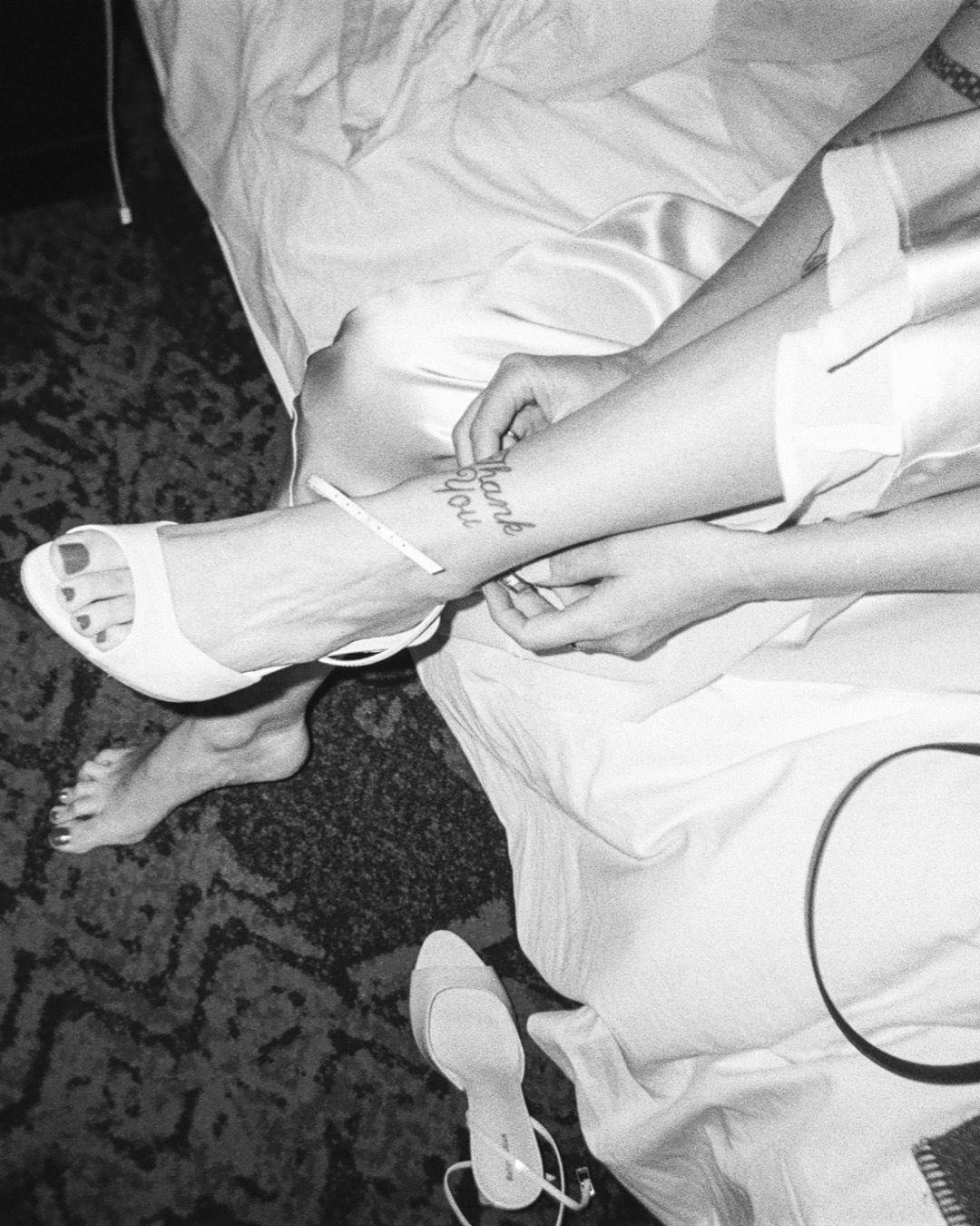 Black and white detail shots of wedding dress alterations and fittings.