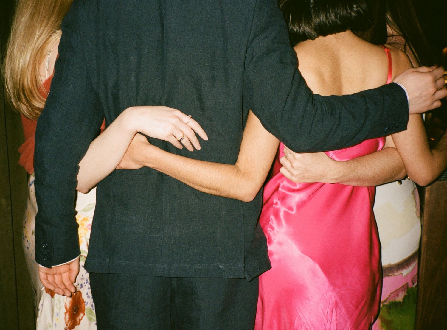 Couples slow dancing in formal attire at wedding reception.