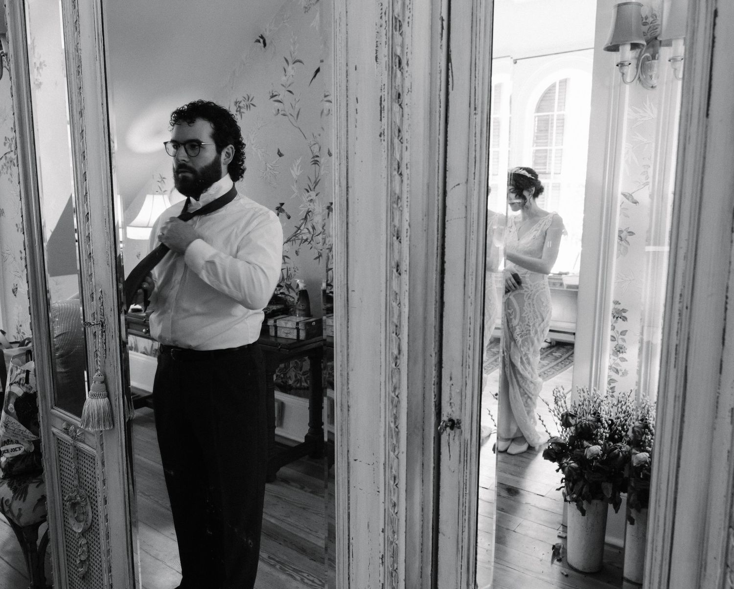 Black and white photos showing wedding preparations in an elegant room with vintage details.