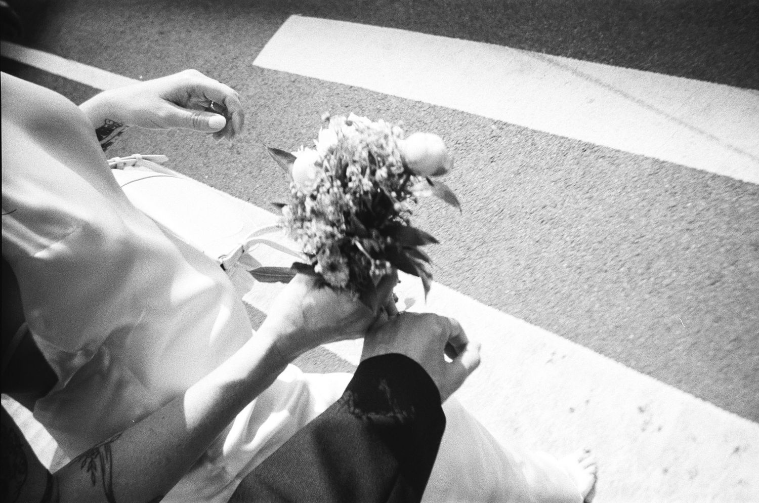 Black and white photo series showing wedding dress details and bouquet.