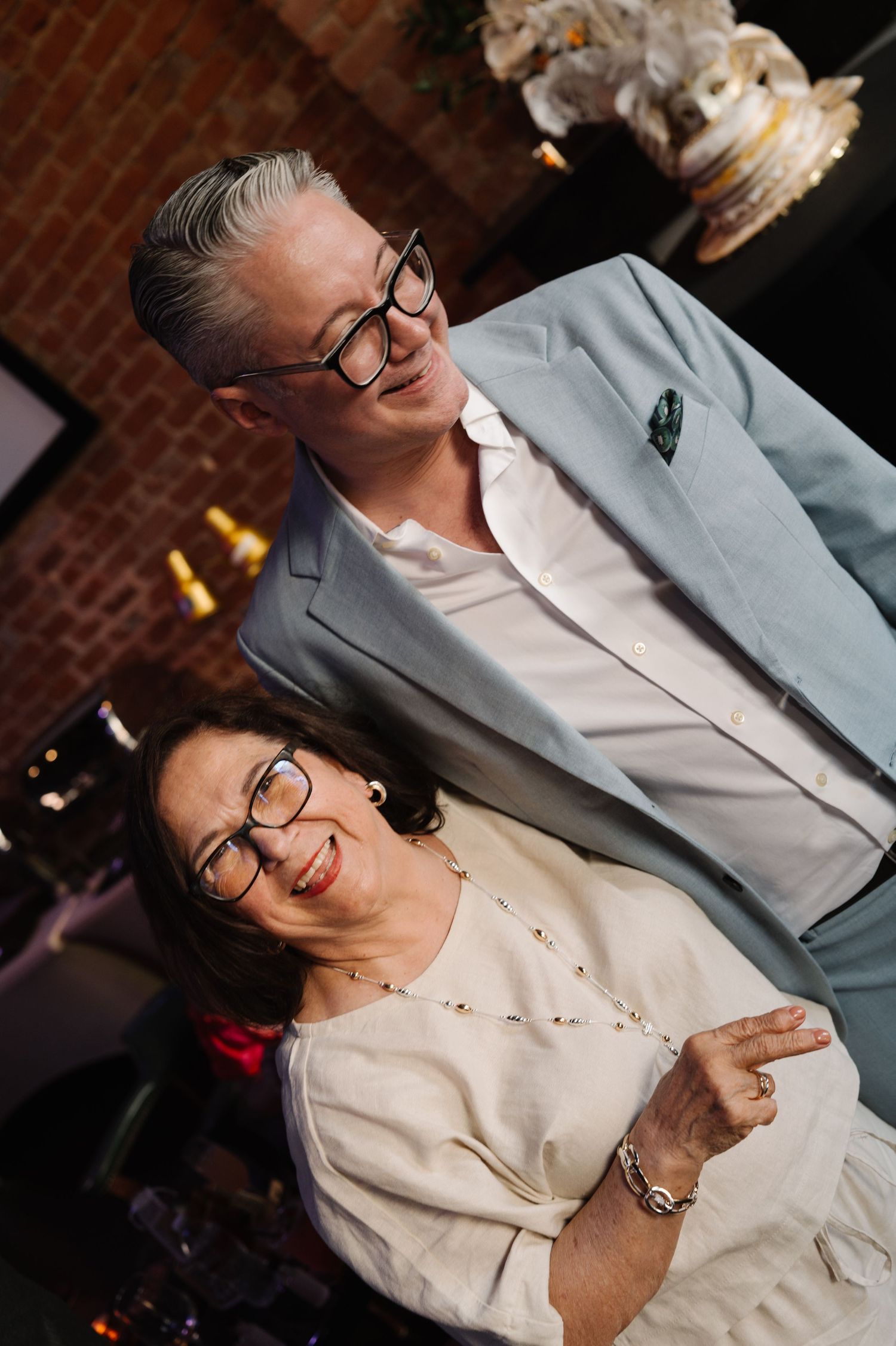 A couple sharing a joyful moment at an indoor wedding.