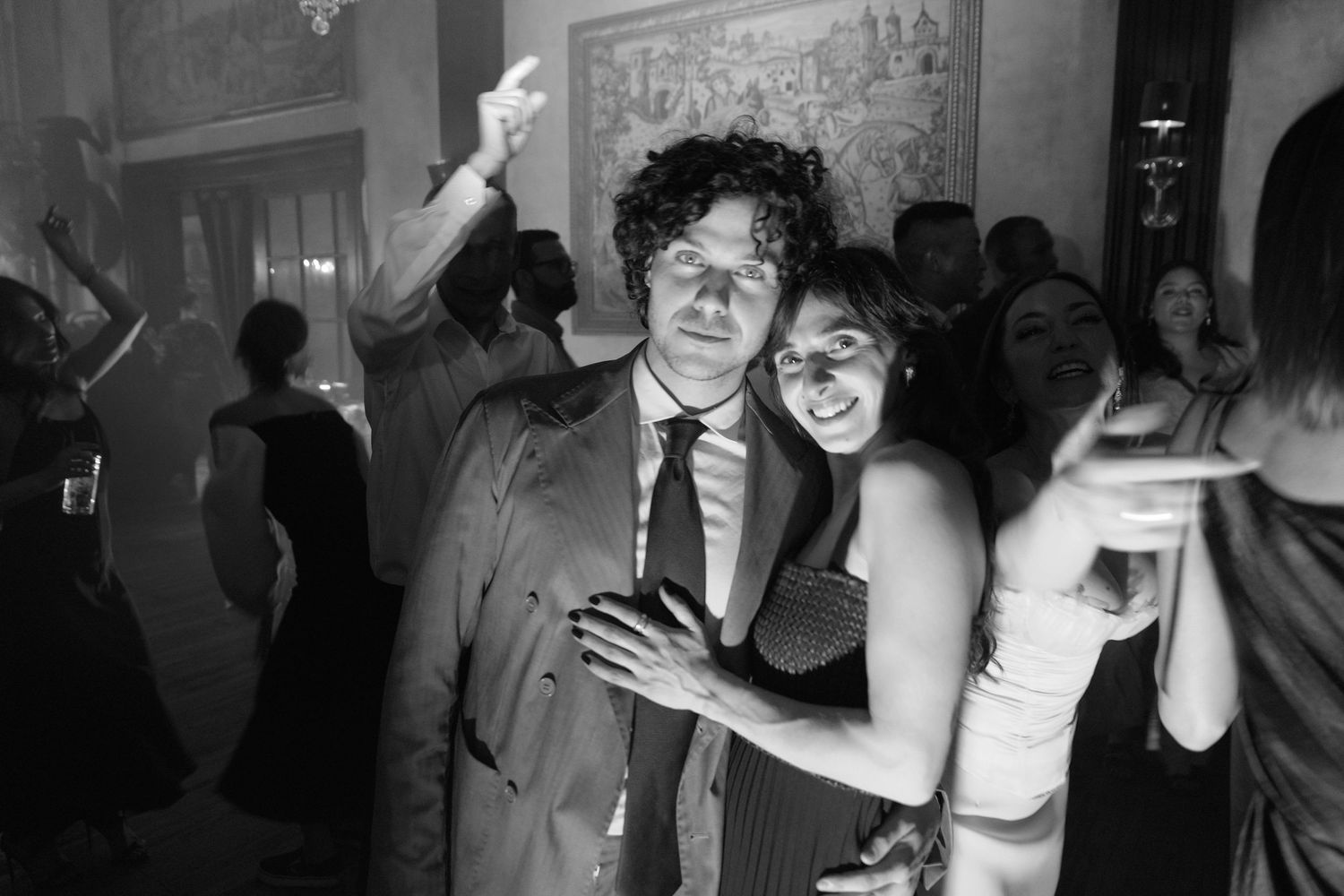 Black and white photo of dancing couples at a wedding reception.