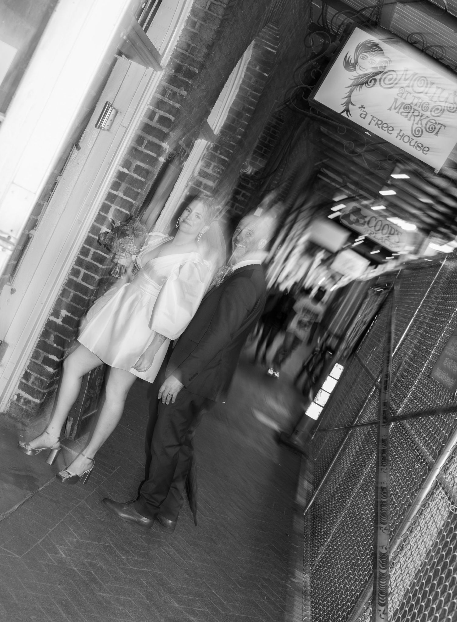 Black and white photo of people moving through the streets of New Orleans.