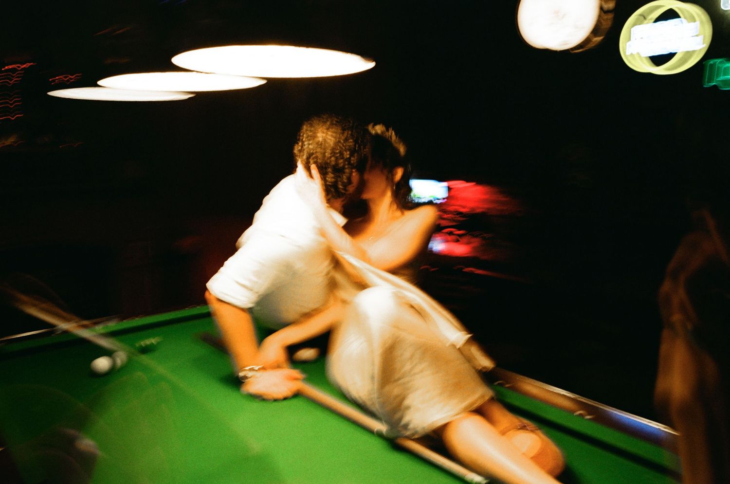 Wedding after-party at a dimly lit bar, documentary wedding photography by Palm Meadow Weddings