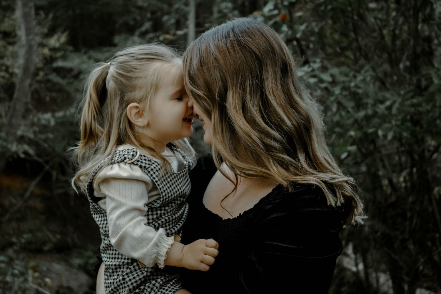 A tender moment between parent and child is captured in a series of moody black and white photographs.