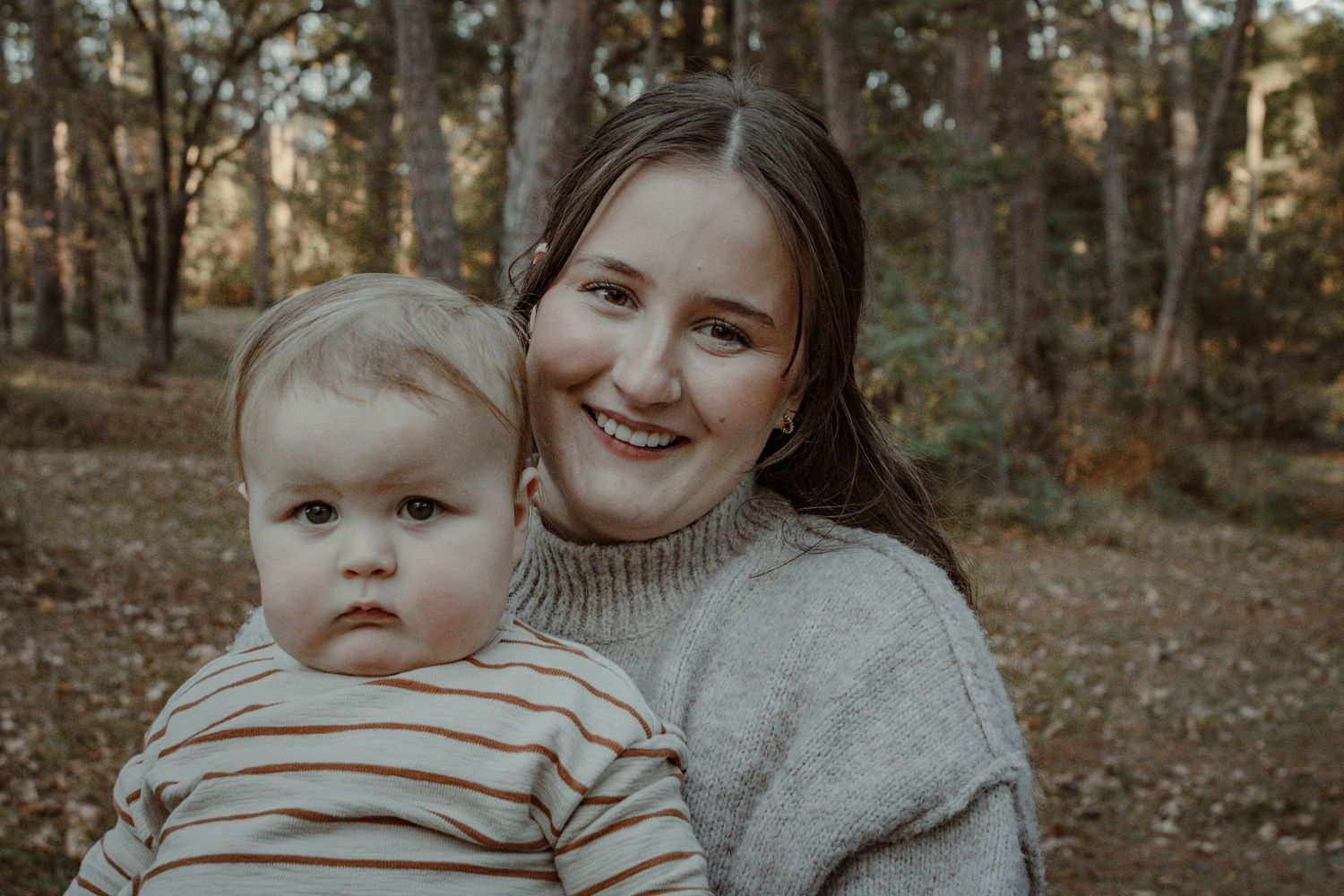 A series of warm-toned outdoor family photos showing tender moments between parent and child in a wooded setting.