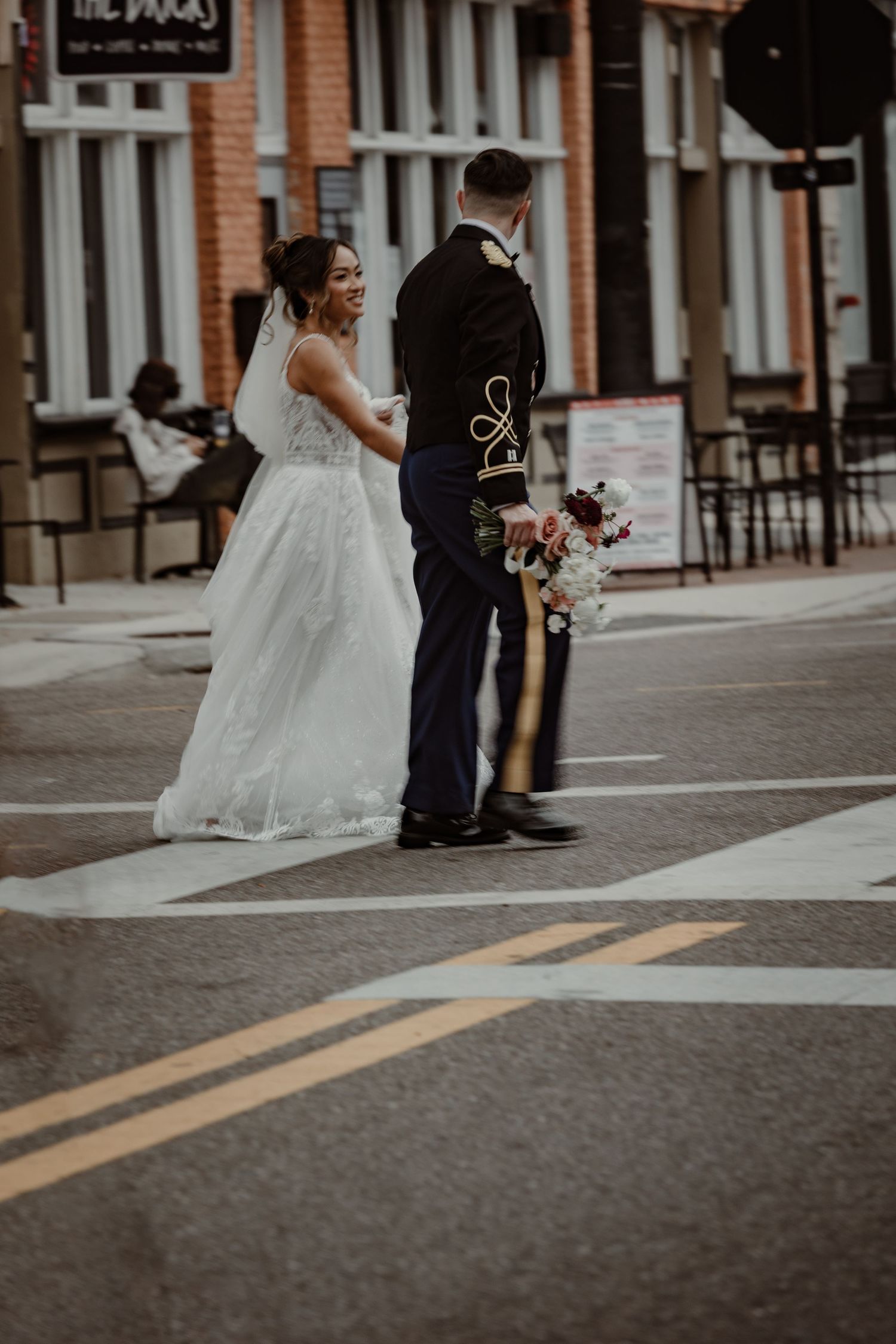 A sequence of wedding photos showing a couple walking down a brick-lined urban street.