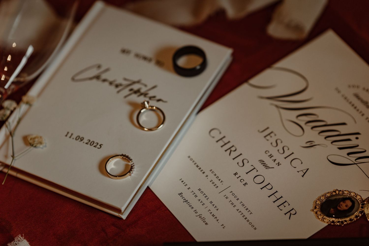 Elegant wedding invitation suite featuring gold rings and calligraphy text on white paper cards.