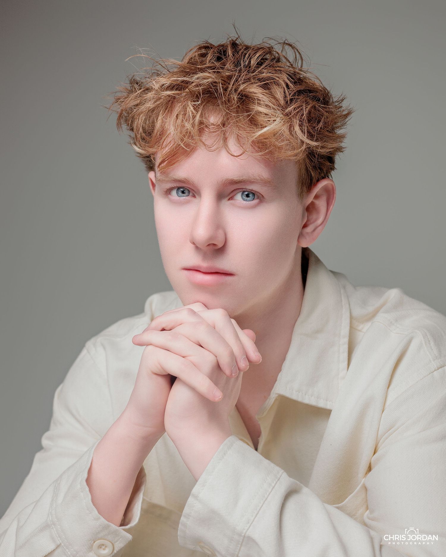 A series of studio portraits showing someone in a white button-up shirt against a neutral gray background.