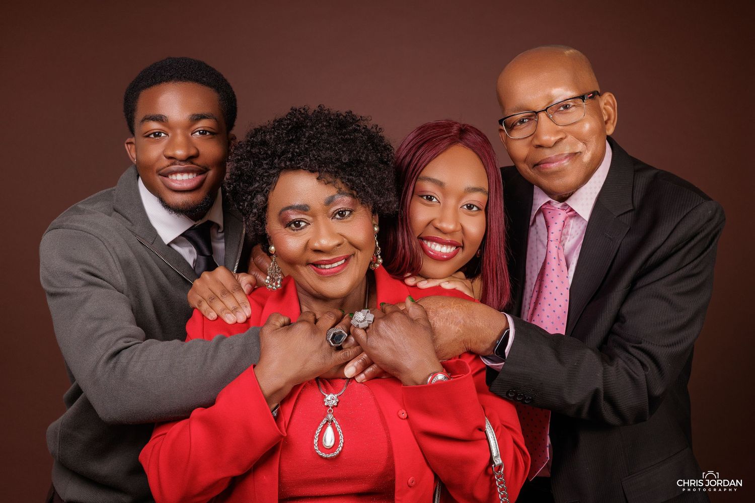 Family portrait series with multiple poses against dark brown background.