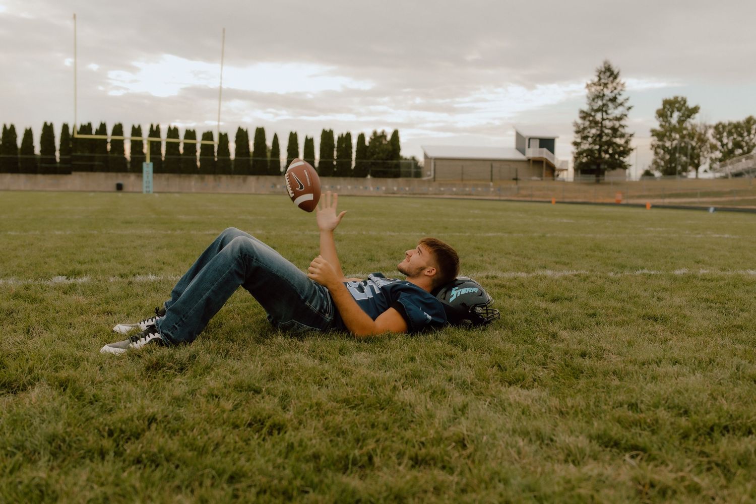 A series of artistic poses on grass showing someone lying down against a cloudy sky.