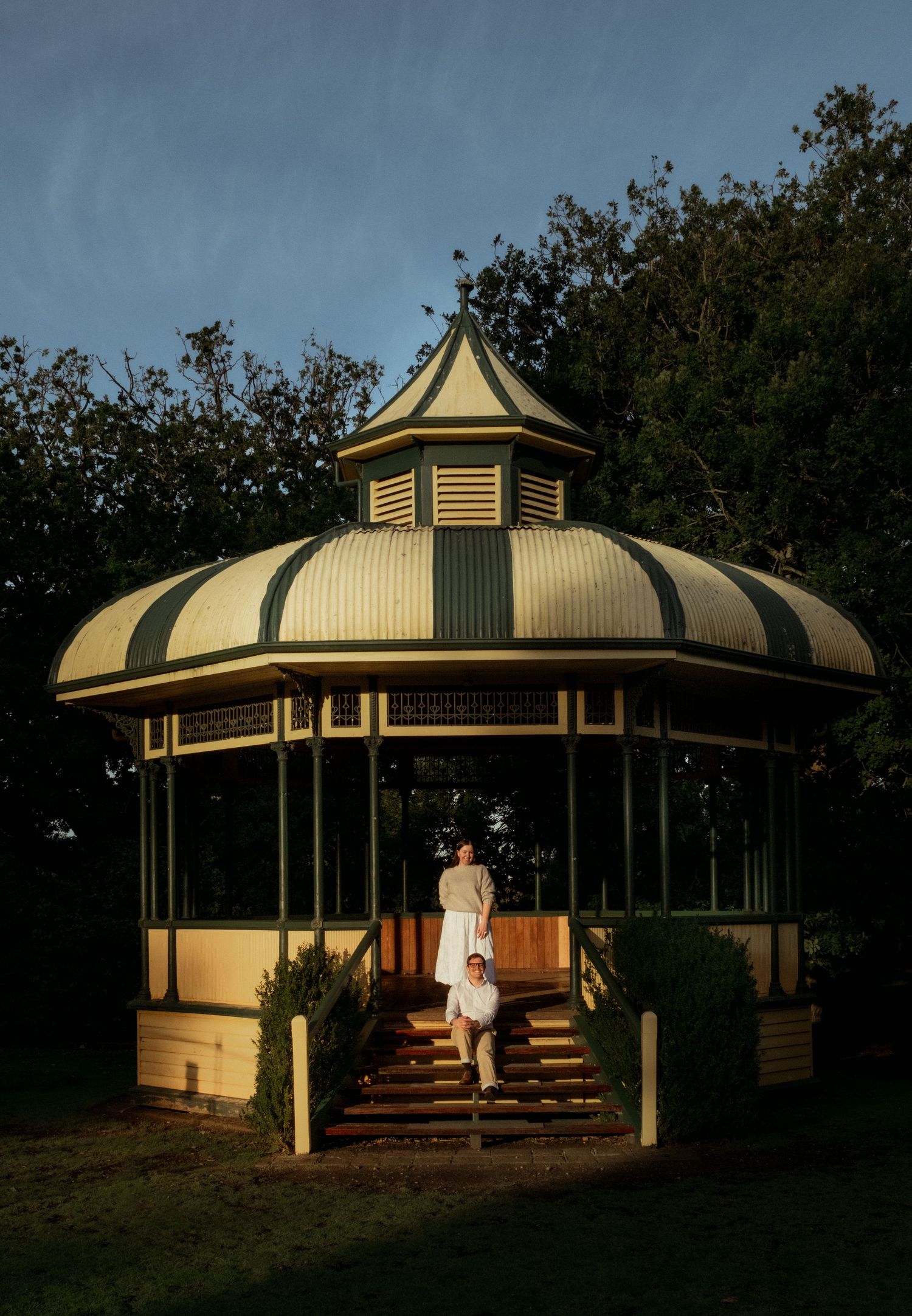 Couple posing at a vintage gazebo at dusk at Warrnambool Botanical Gardens.