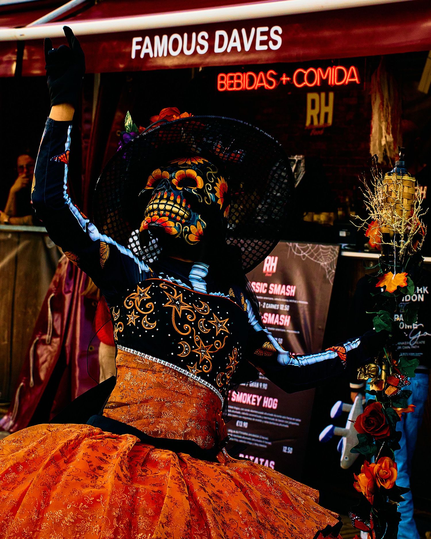 Colorful Day of the Dead themed decoration at Famous Daves restaurant entrance.