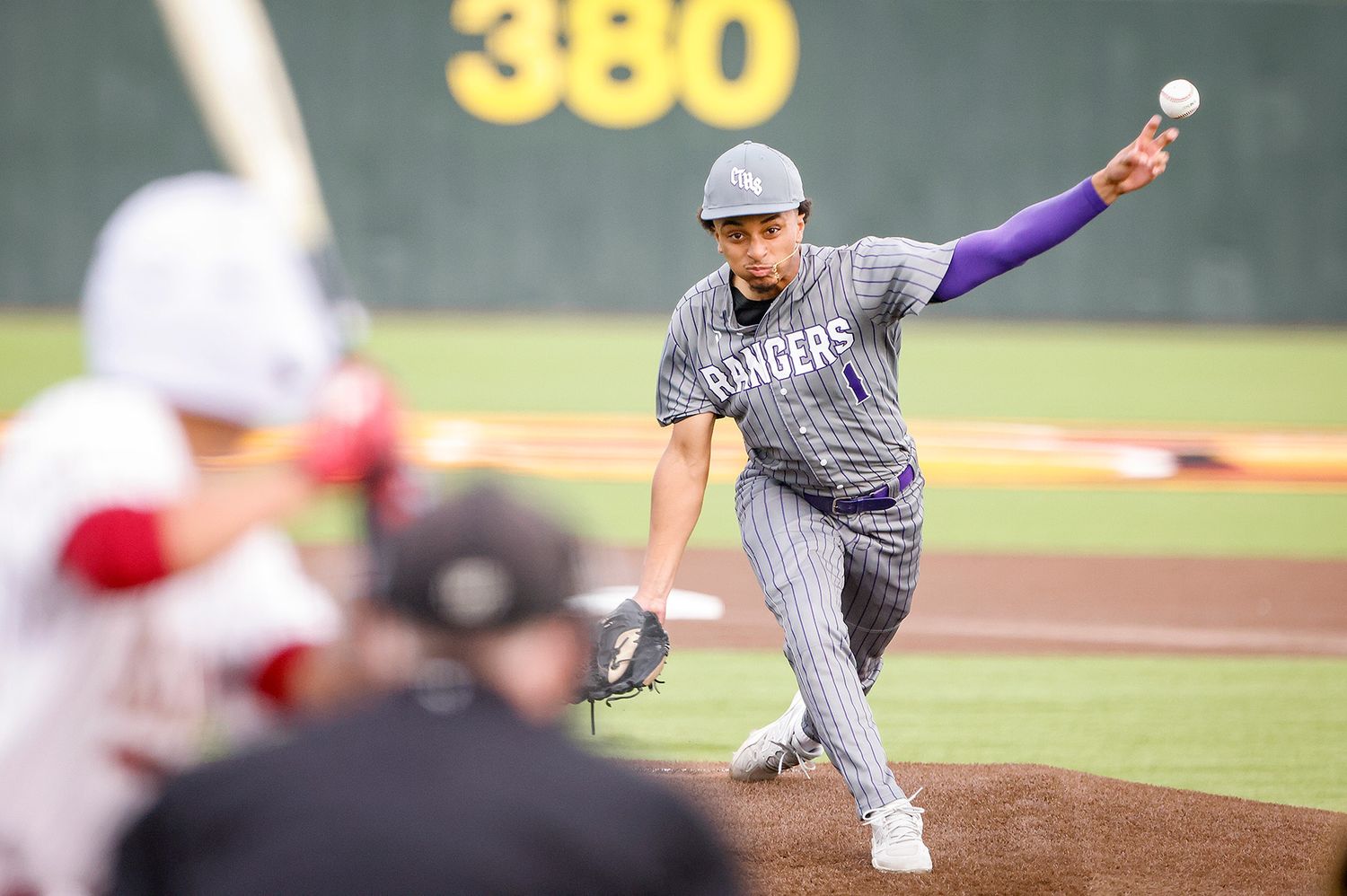 Rangers pitcher delivers a pitch from the mound during a competitive baseball game at a stadium.