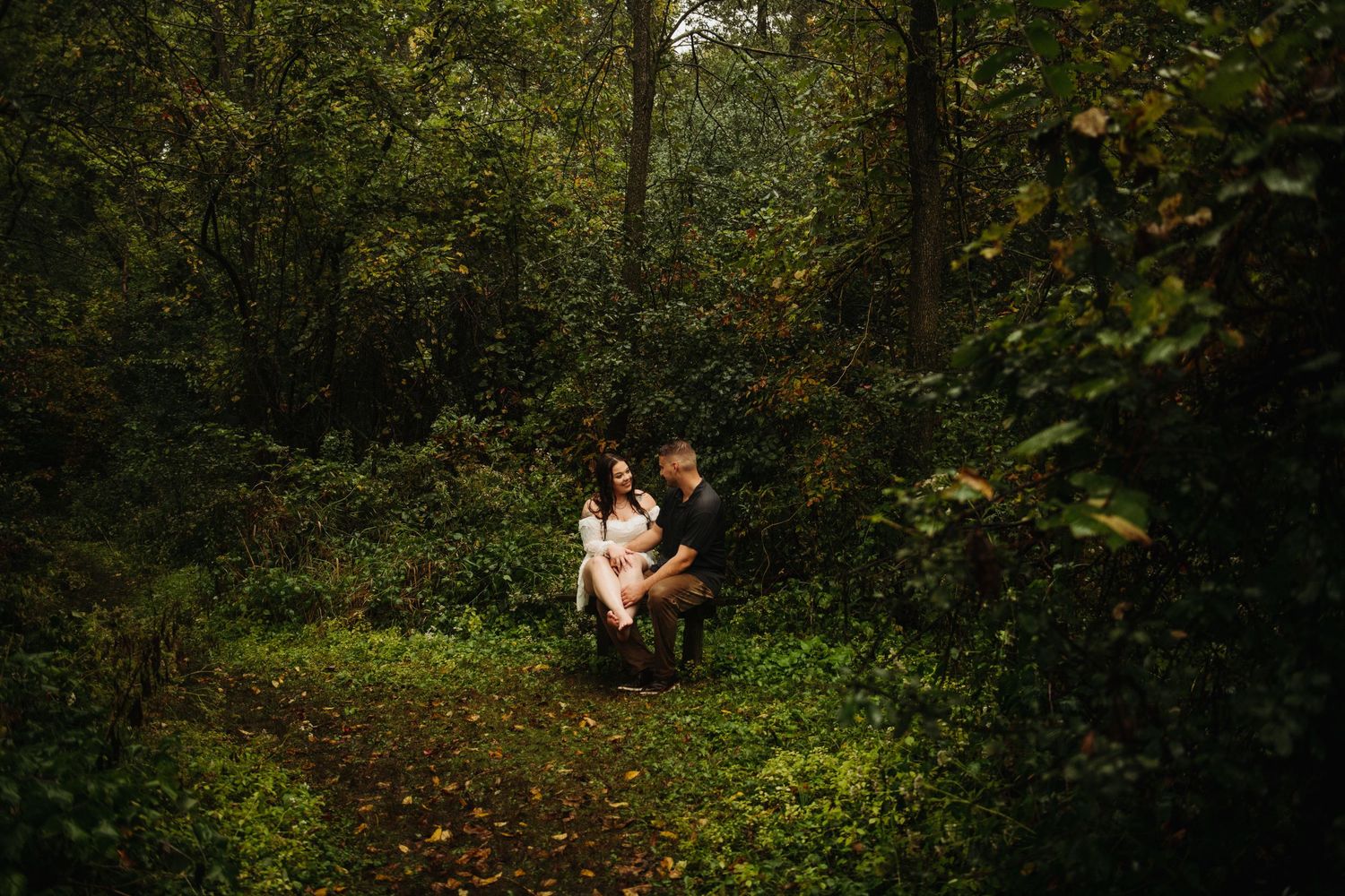 couple in engagement pictures in woods