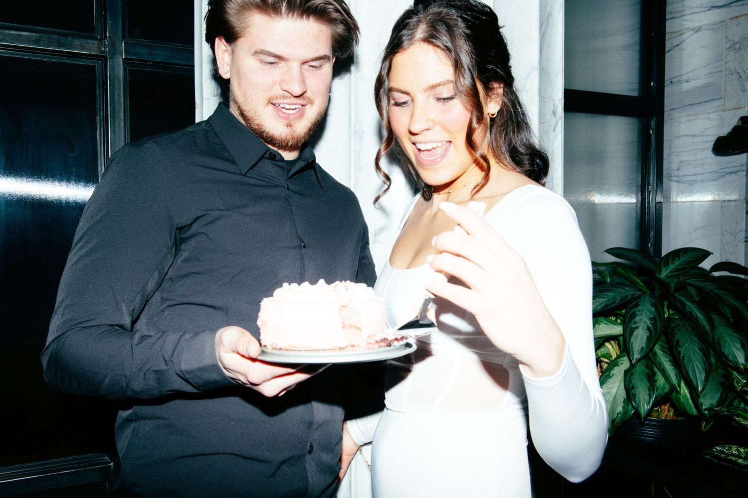 engagement photo of couple with direct flash eating cake