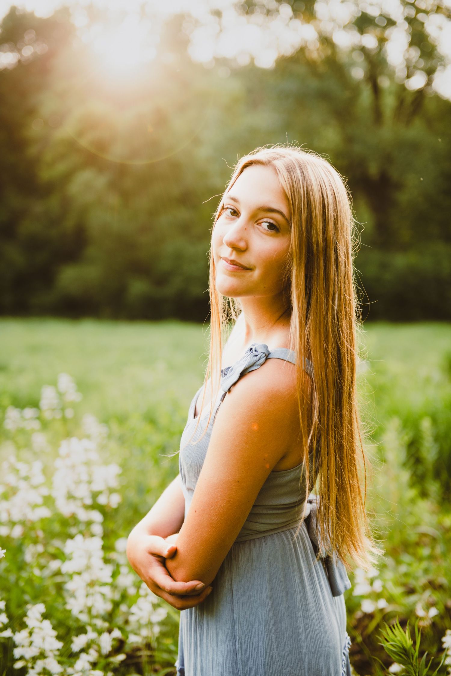 high school senior girl pictures in a field with flowers