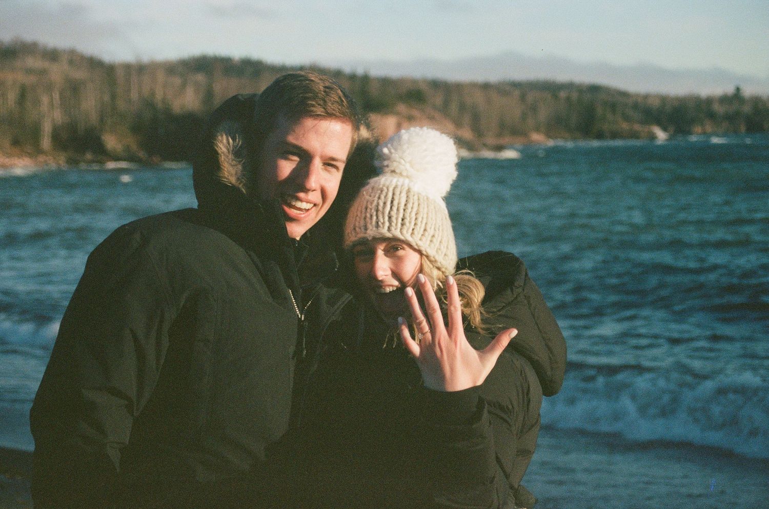 film photo of couple showing off engagement ring