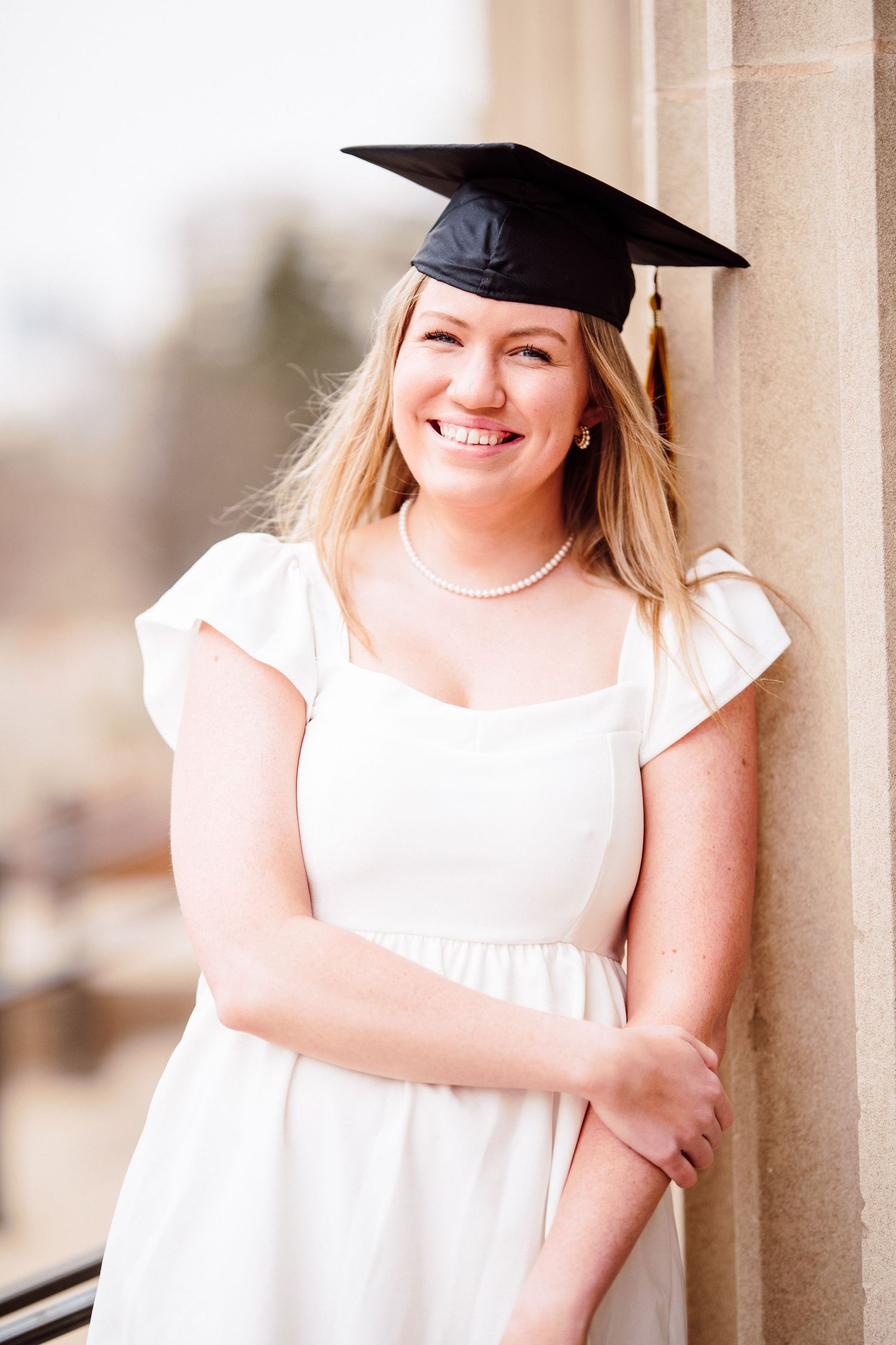 university of minnesota graduate in white dress with sash