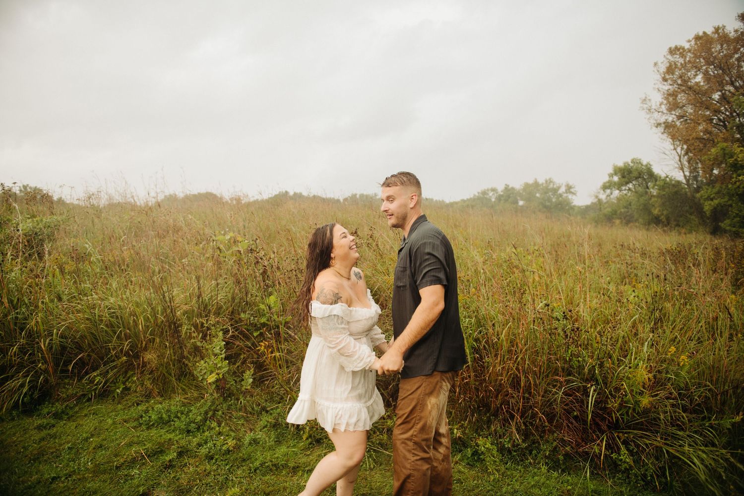 man and woman holding hands engagement photo