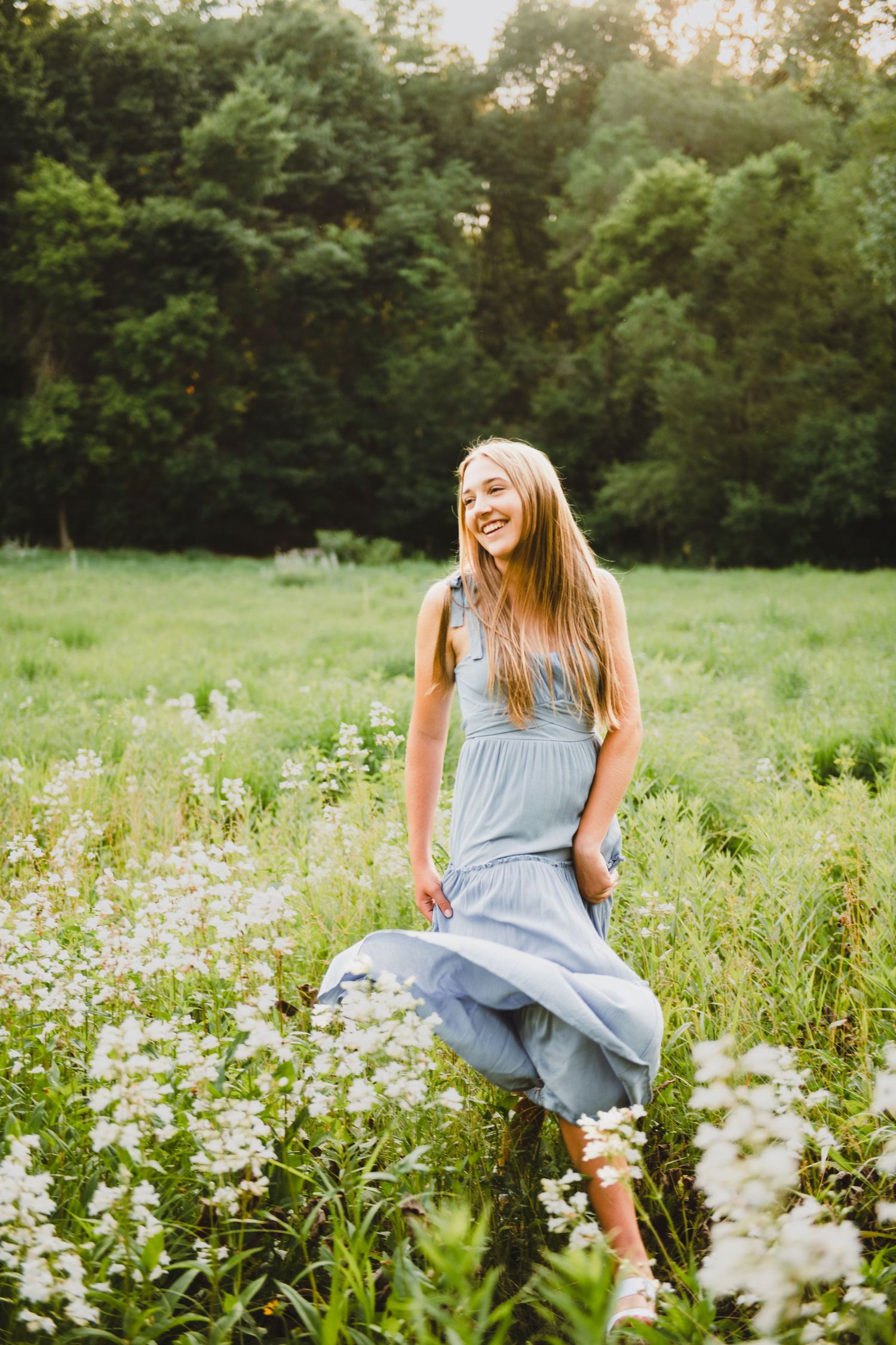 high school senior girl pictures in a field with flowers