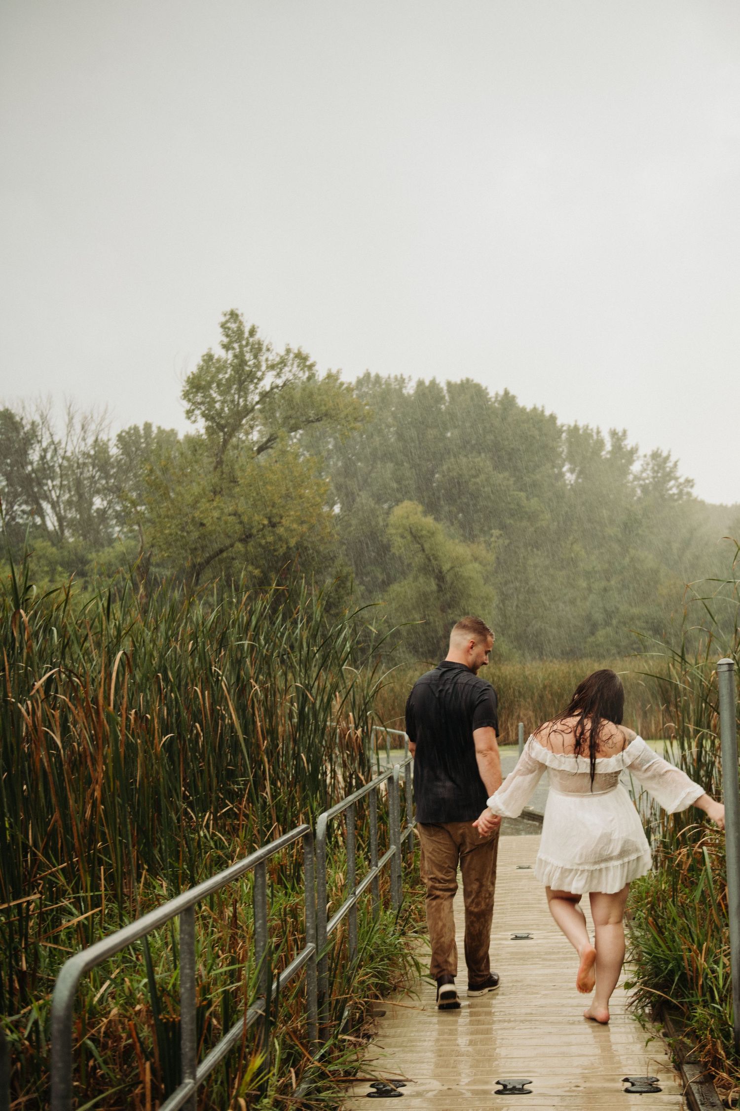 couple in engagement pictures on dock