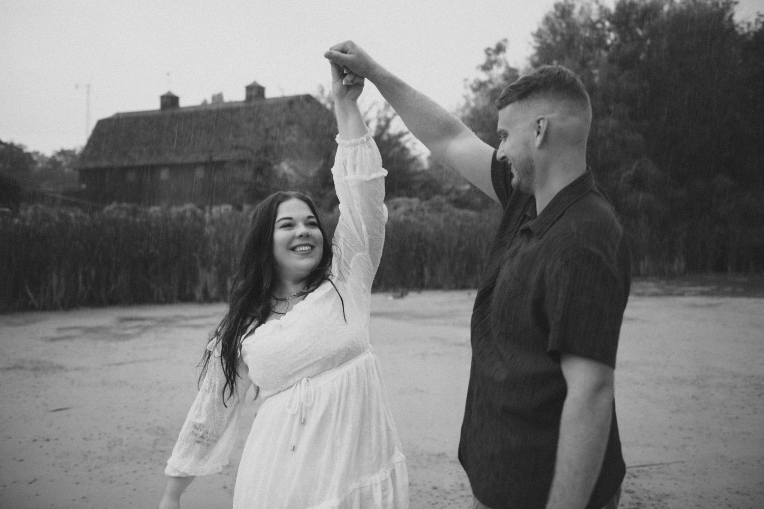 couple dancing in engagement pictures on dock