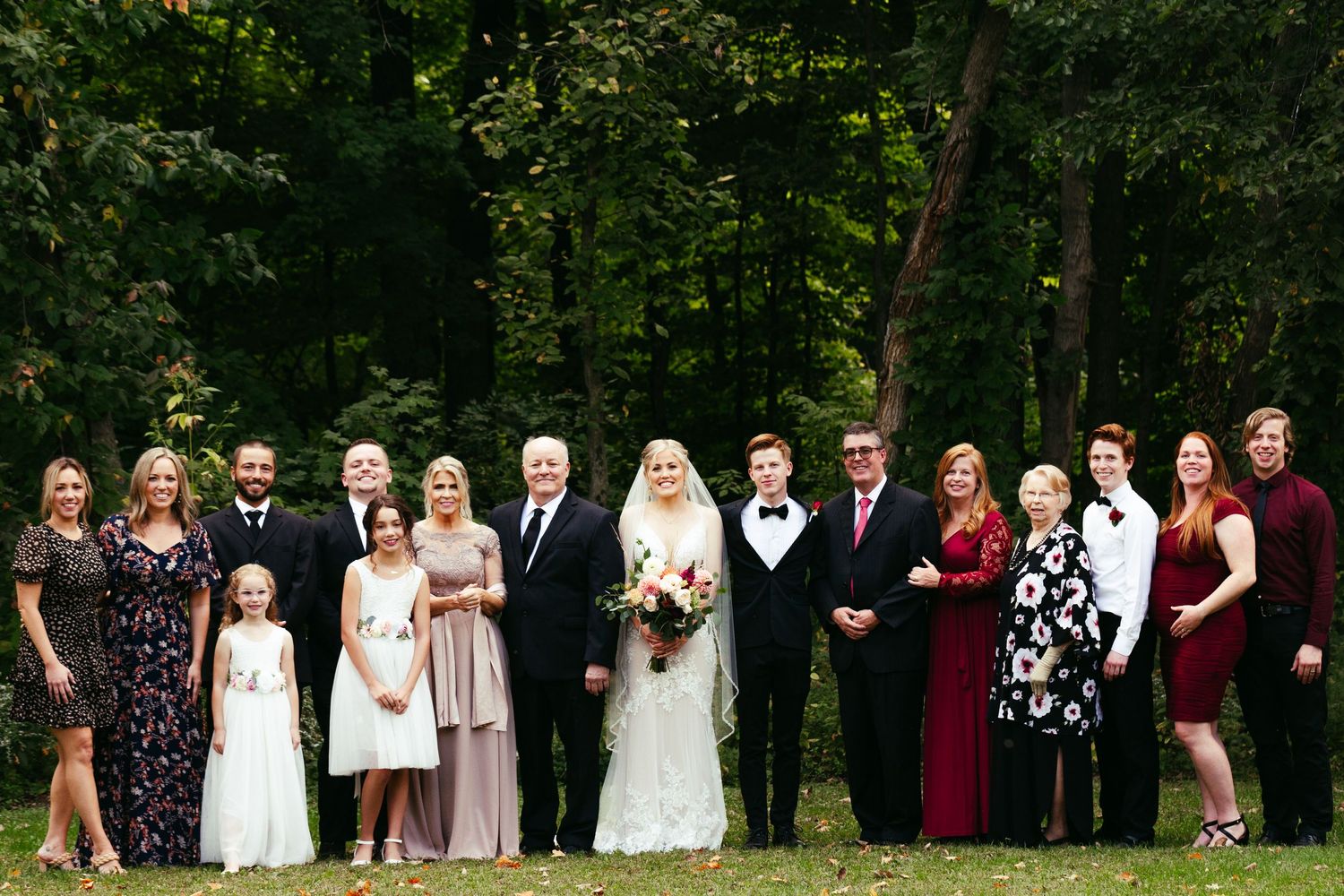 wedding party with bride and groom in middle