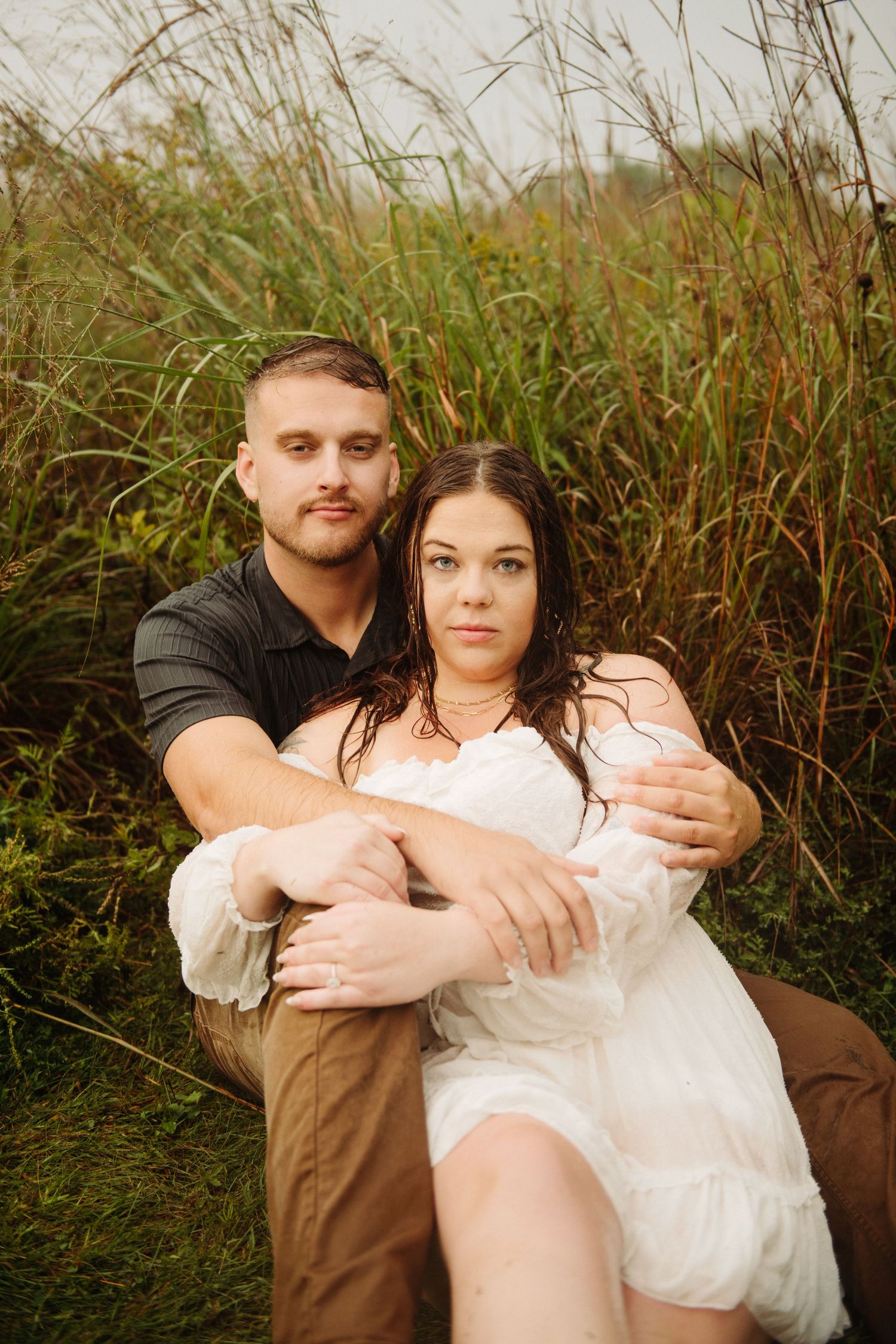 couple in engagement pictures in field