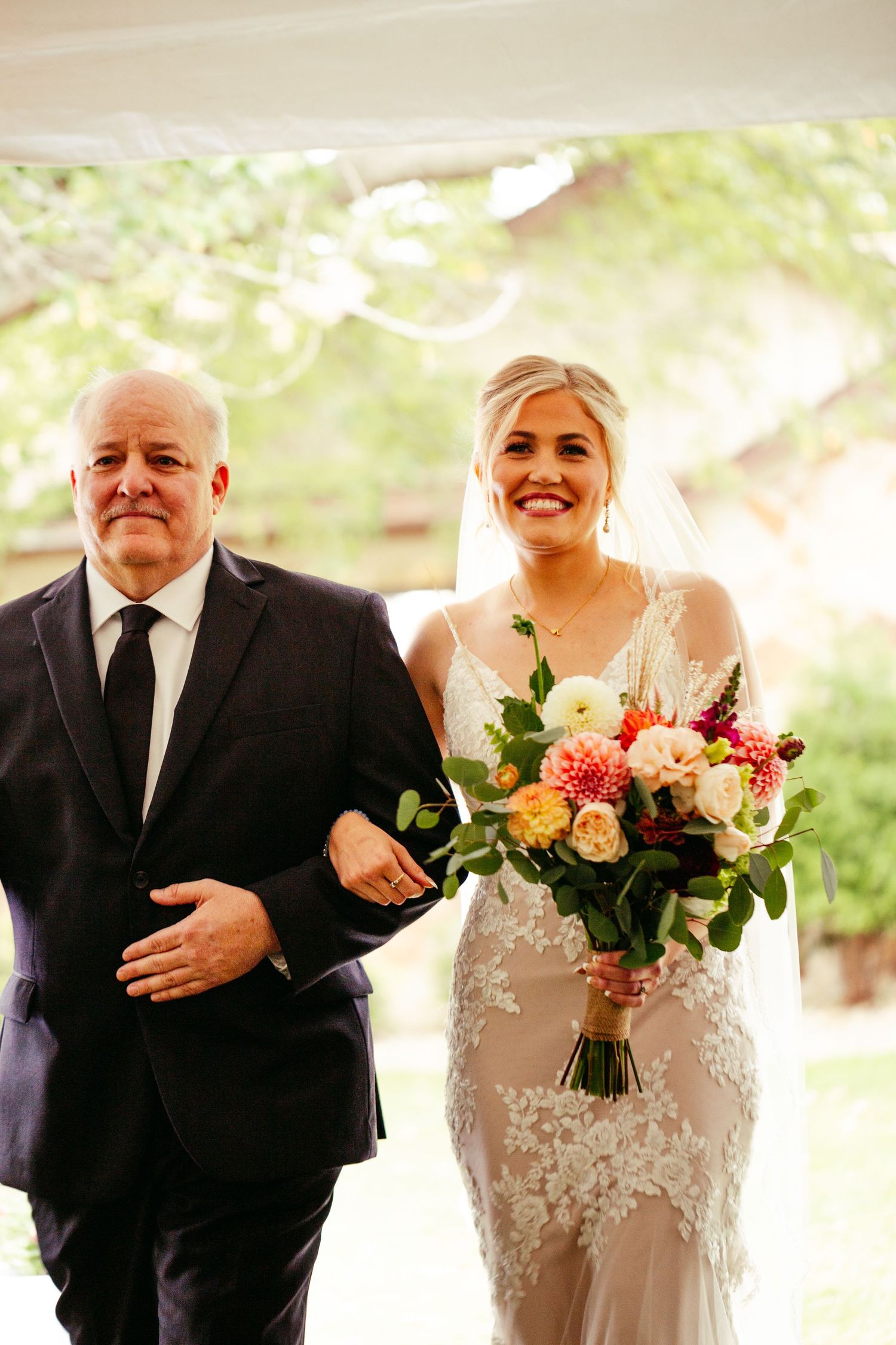 bride walking down aisle with father