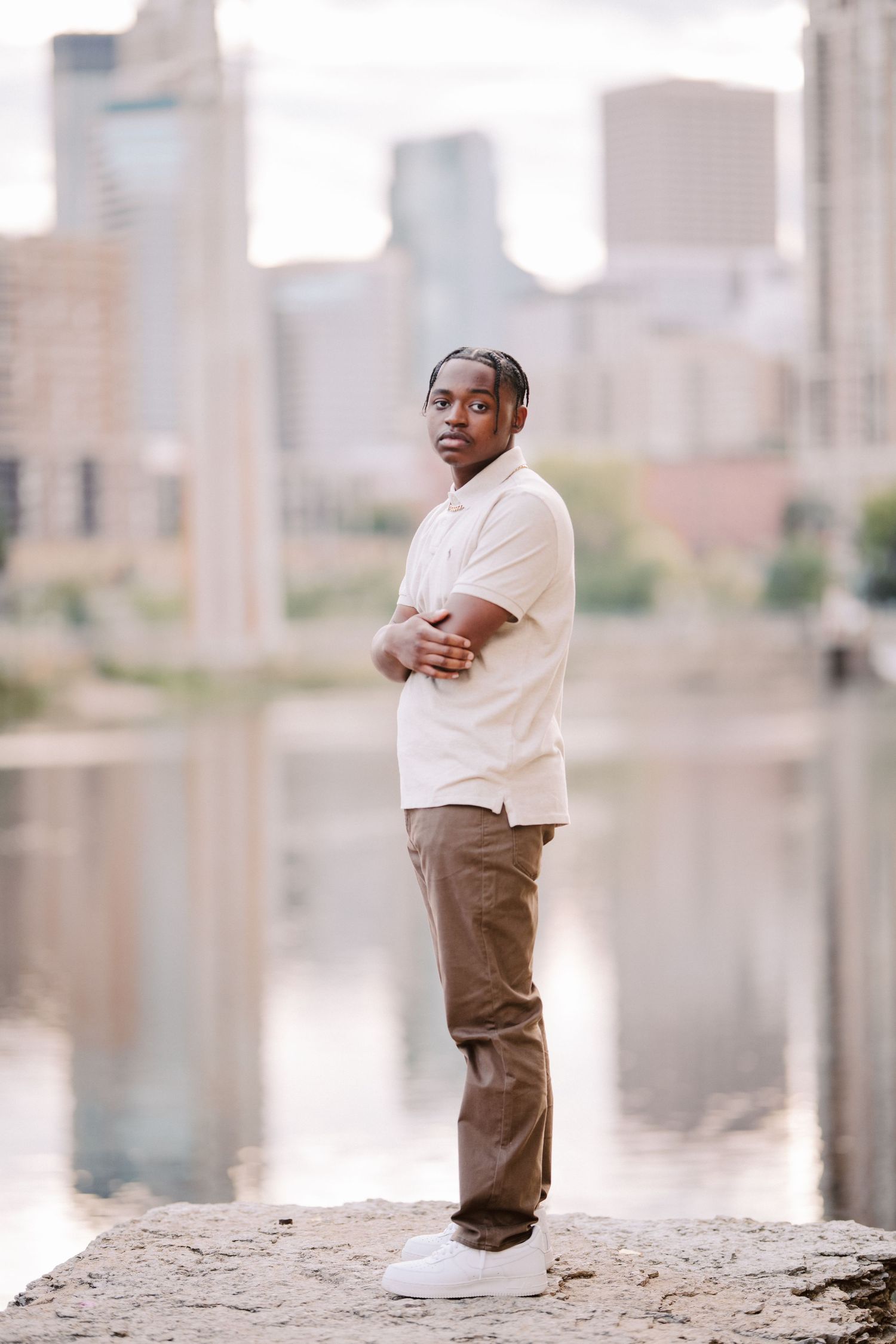 senior guy pictures in minneapolis standing on rock