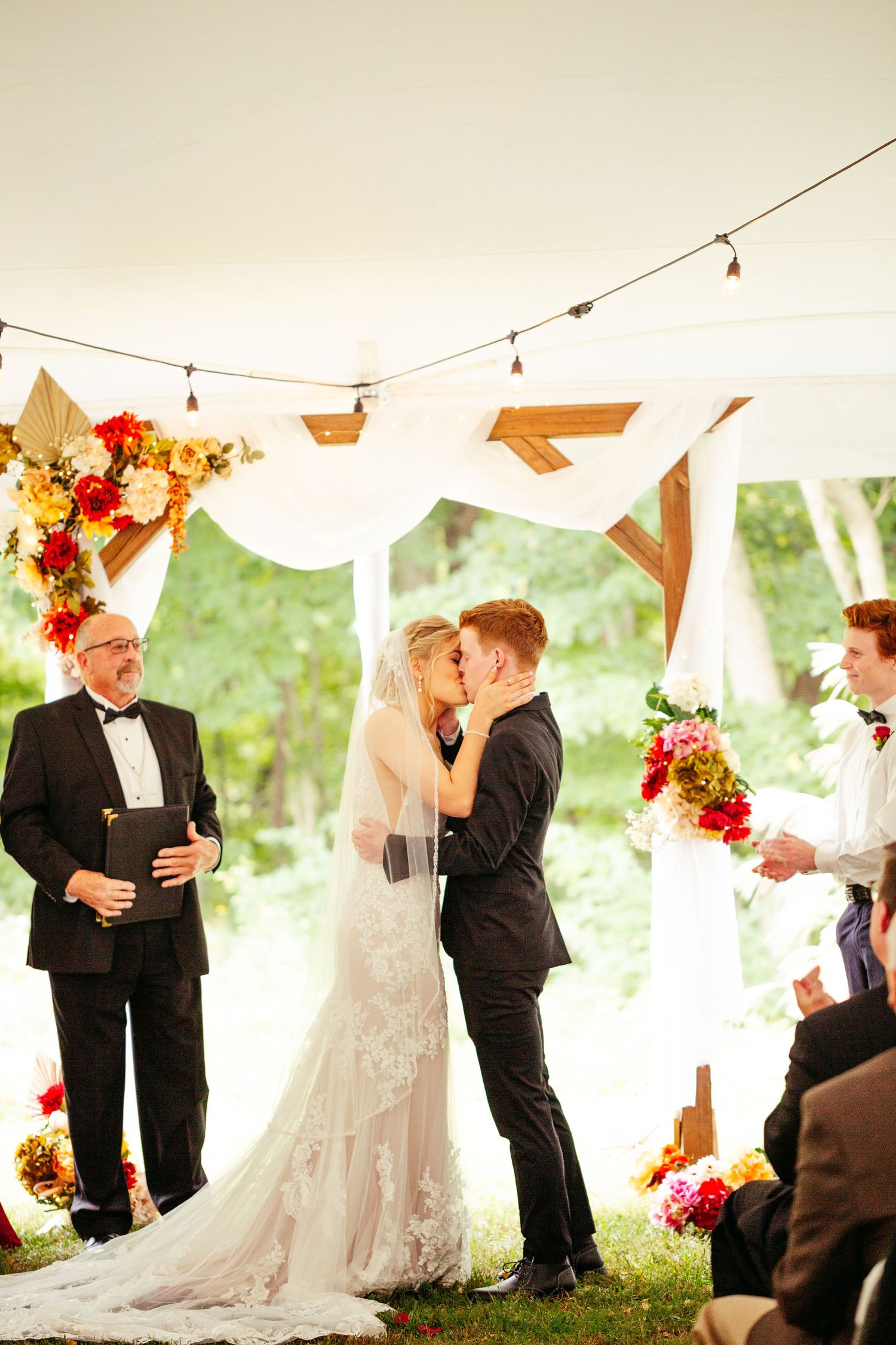 bride and groom kiss at the altar
