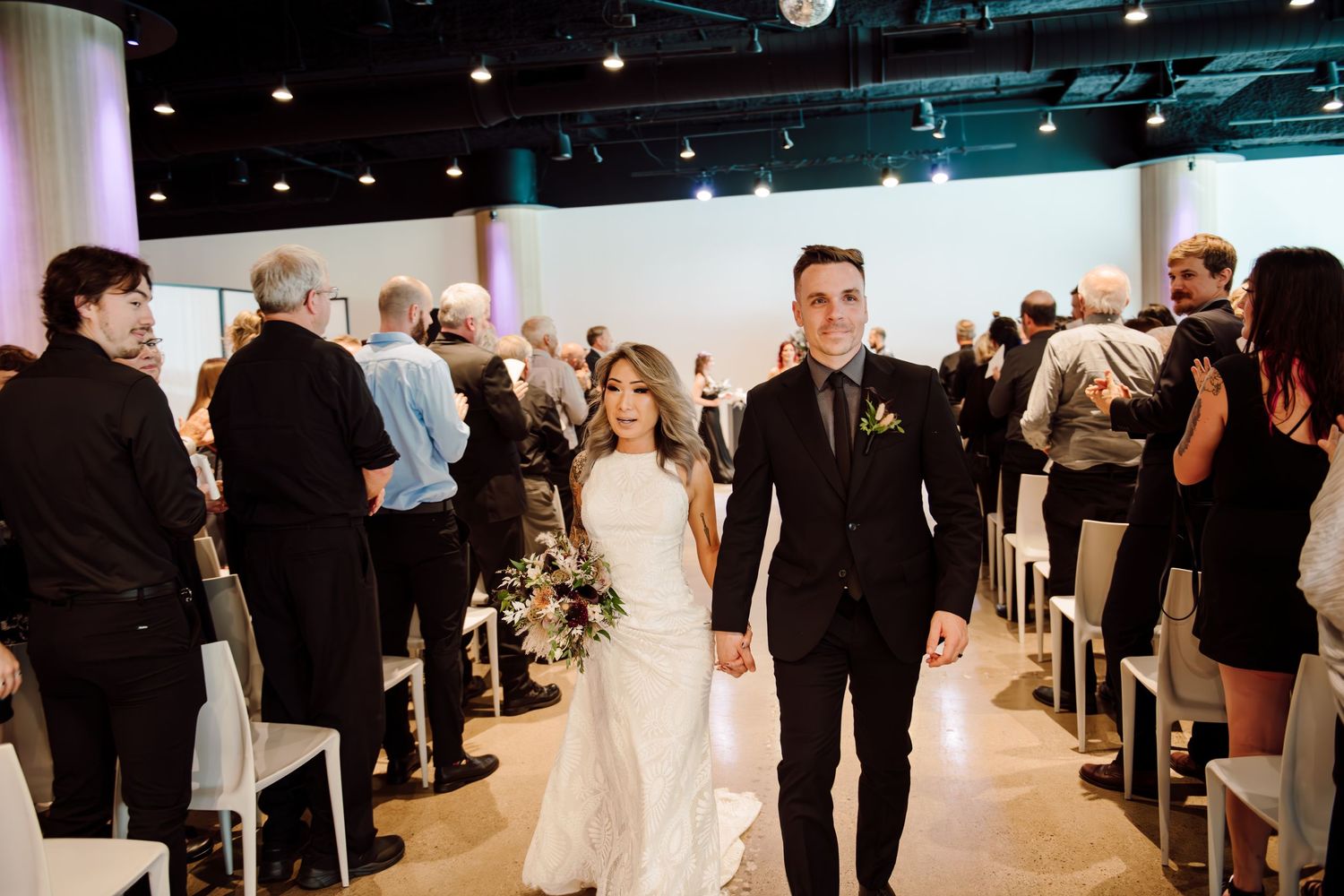 bride and groom walking down aisle after wedding