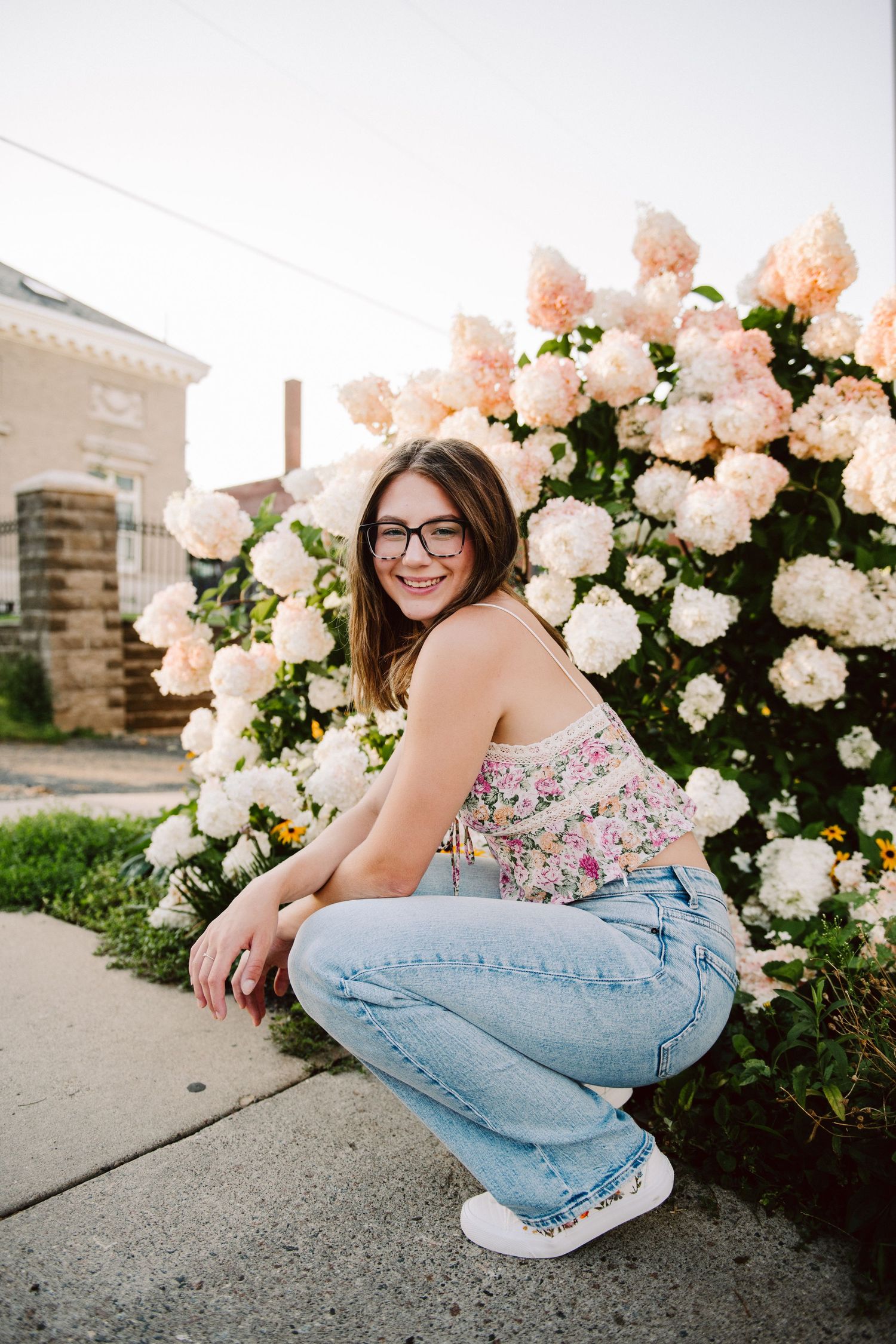 high school senior girl pictures in front of lilac bush