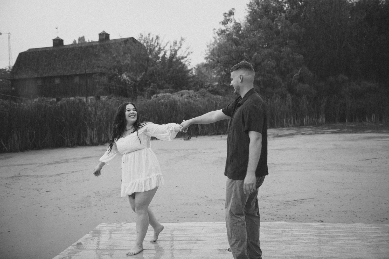 couple dancing in engagement pictures on dock