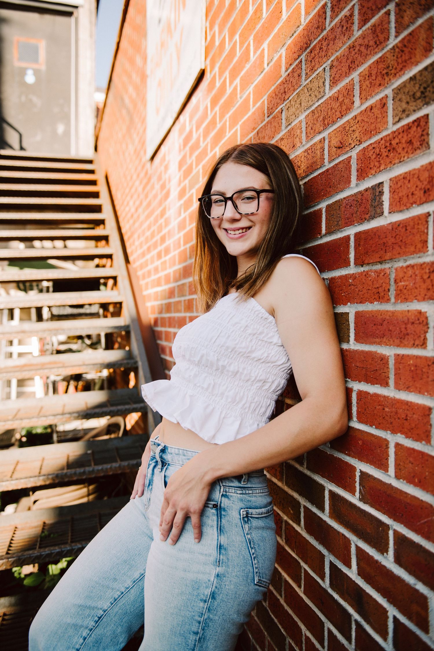 high school senior against brick wall