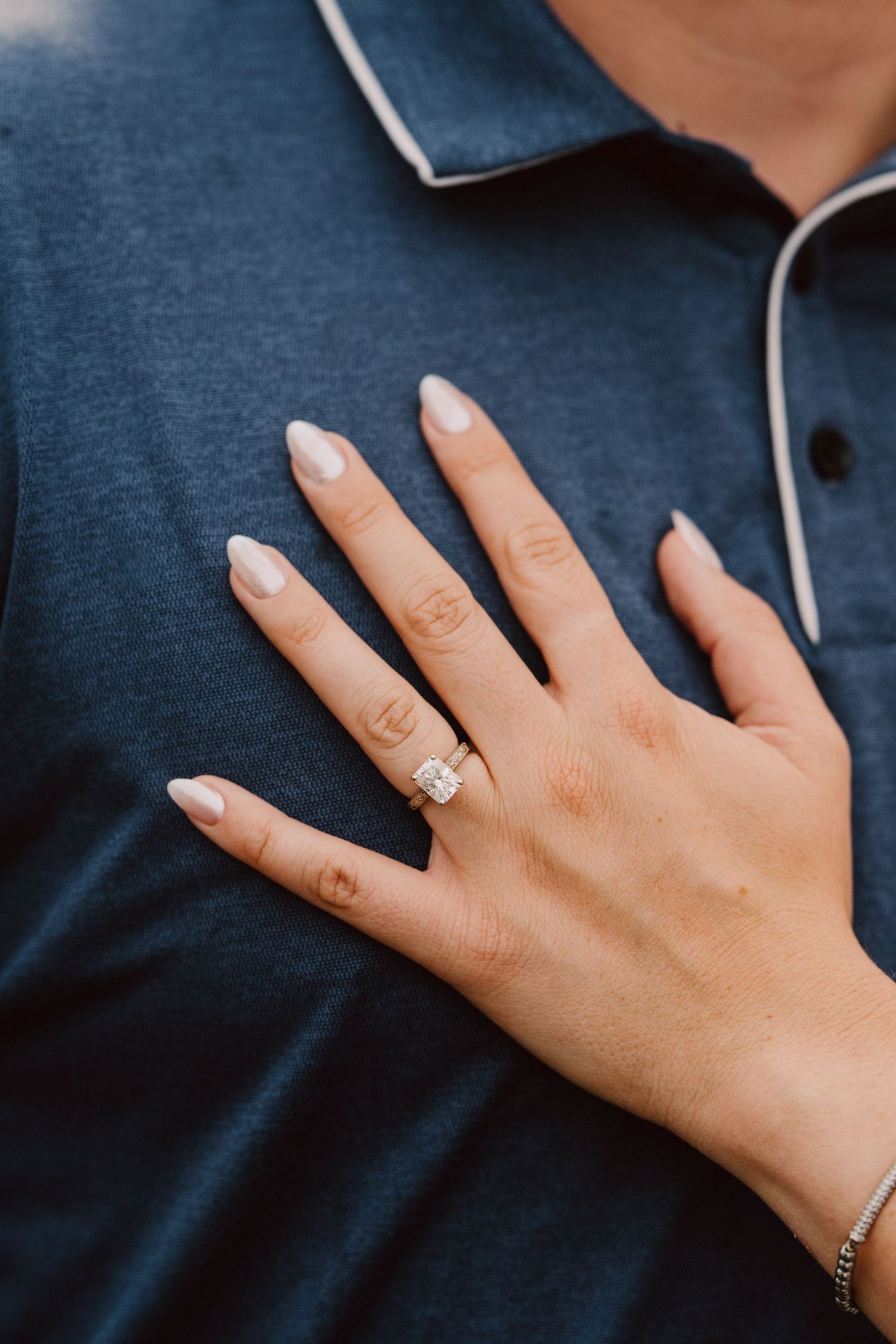 ring on hand on chest