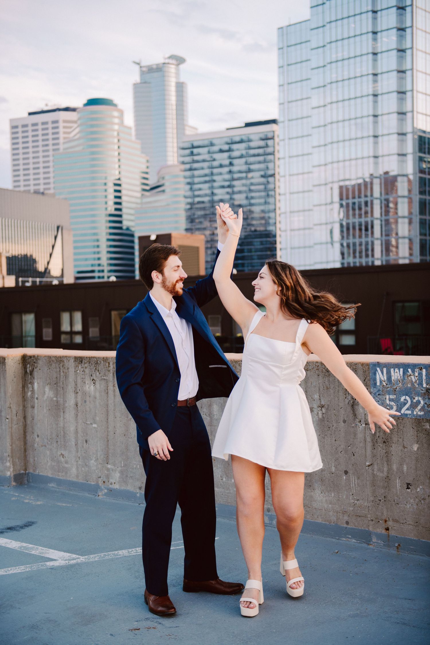 engagement pictures couple dancing on minneapolis rooftop