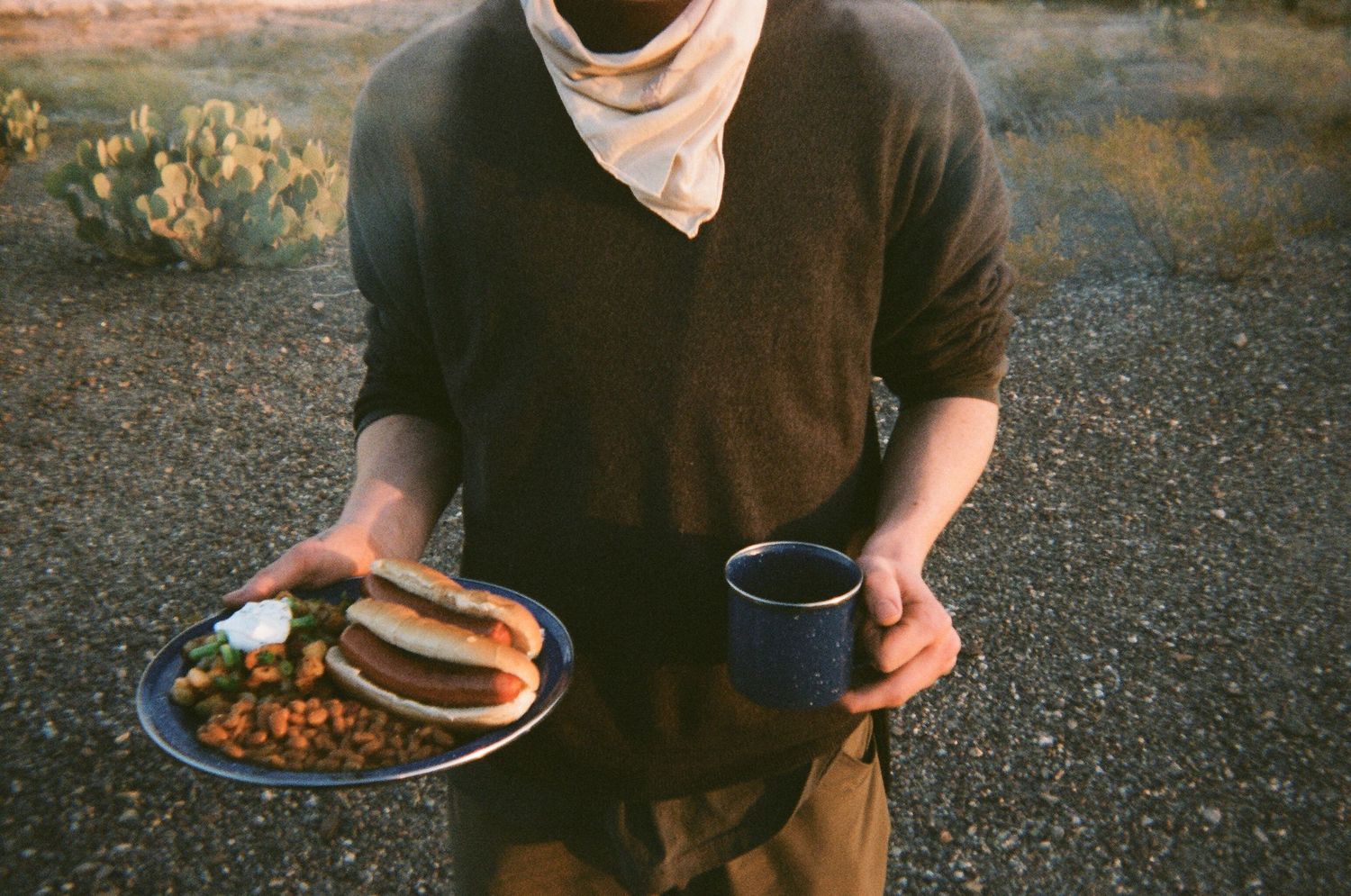 film photo of man with plate of dinner food and cup of coffee