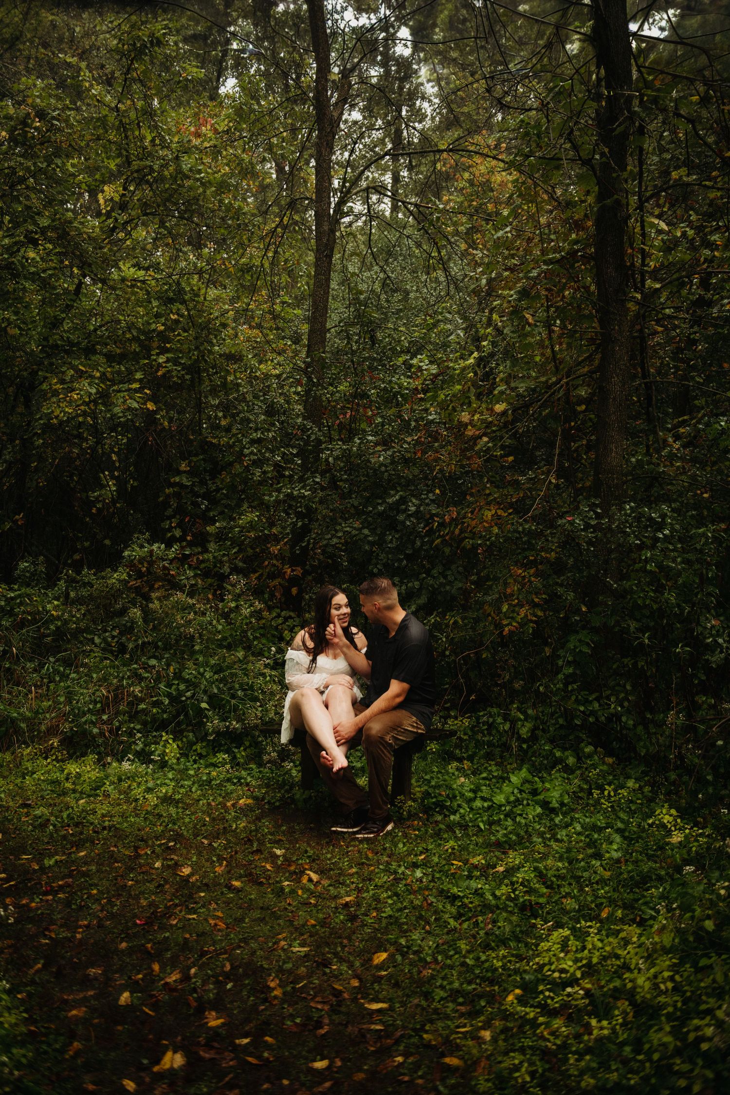 couple in engagement pictures in woods