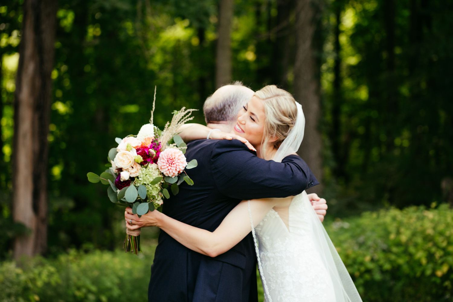bride and father hugging first look