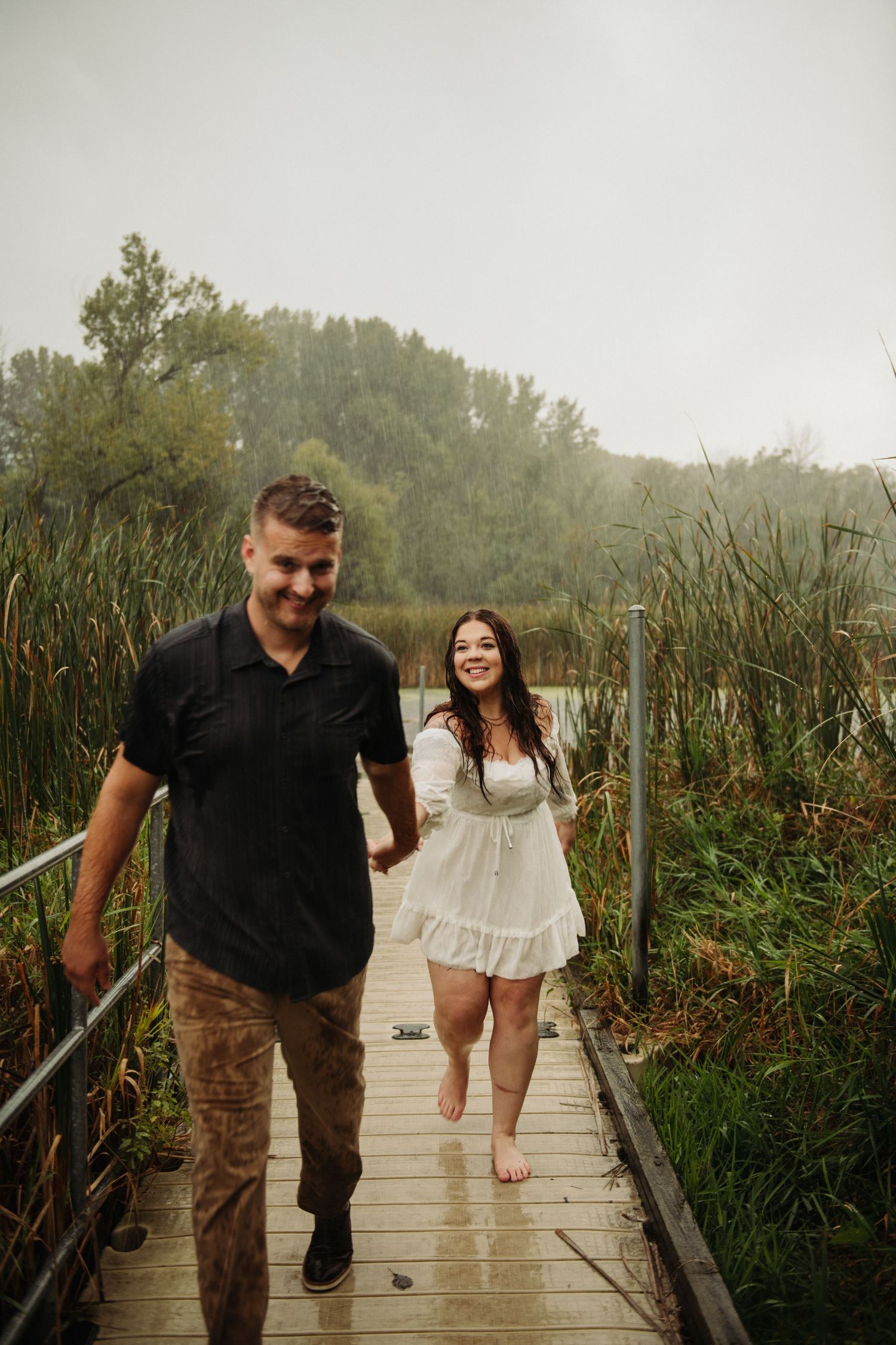 couple in engagement pictures on dock