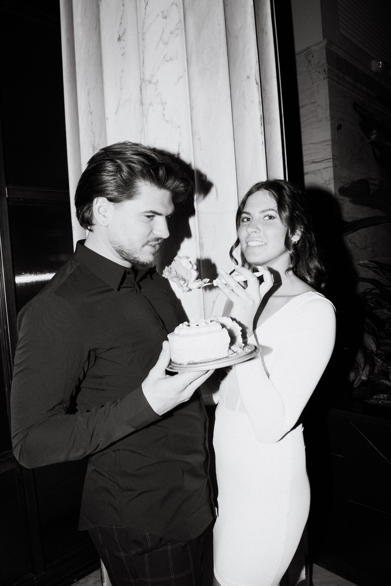engagement photo of couple with direct flash eating cake