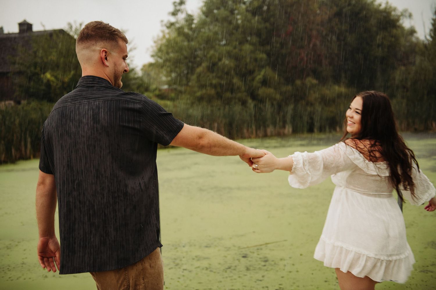 couple dancing in engagement pictures on dock