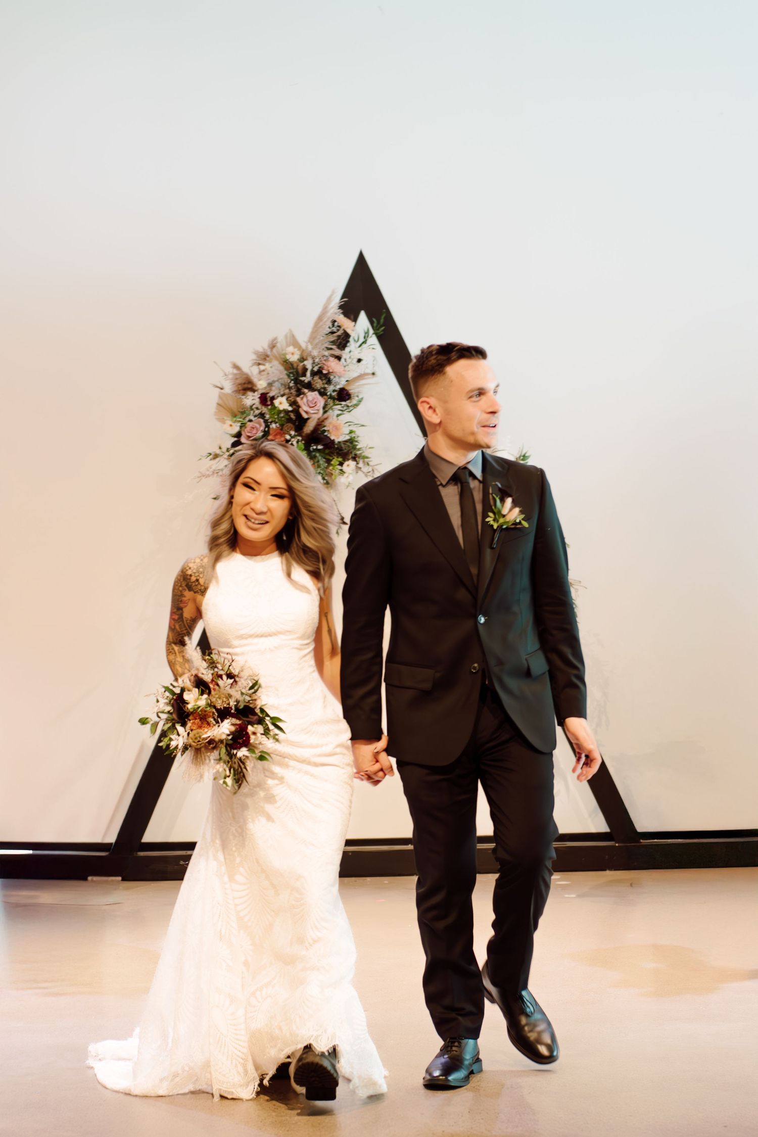 bride and groom walking down aisle after wedding