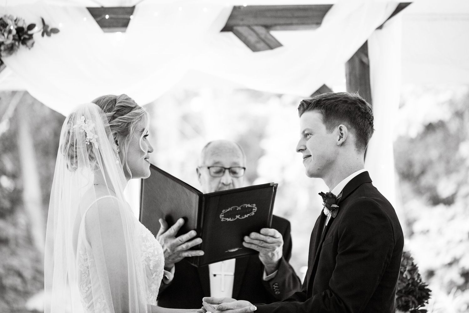 bride and groom at altar black and white