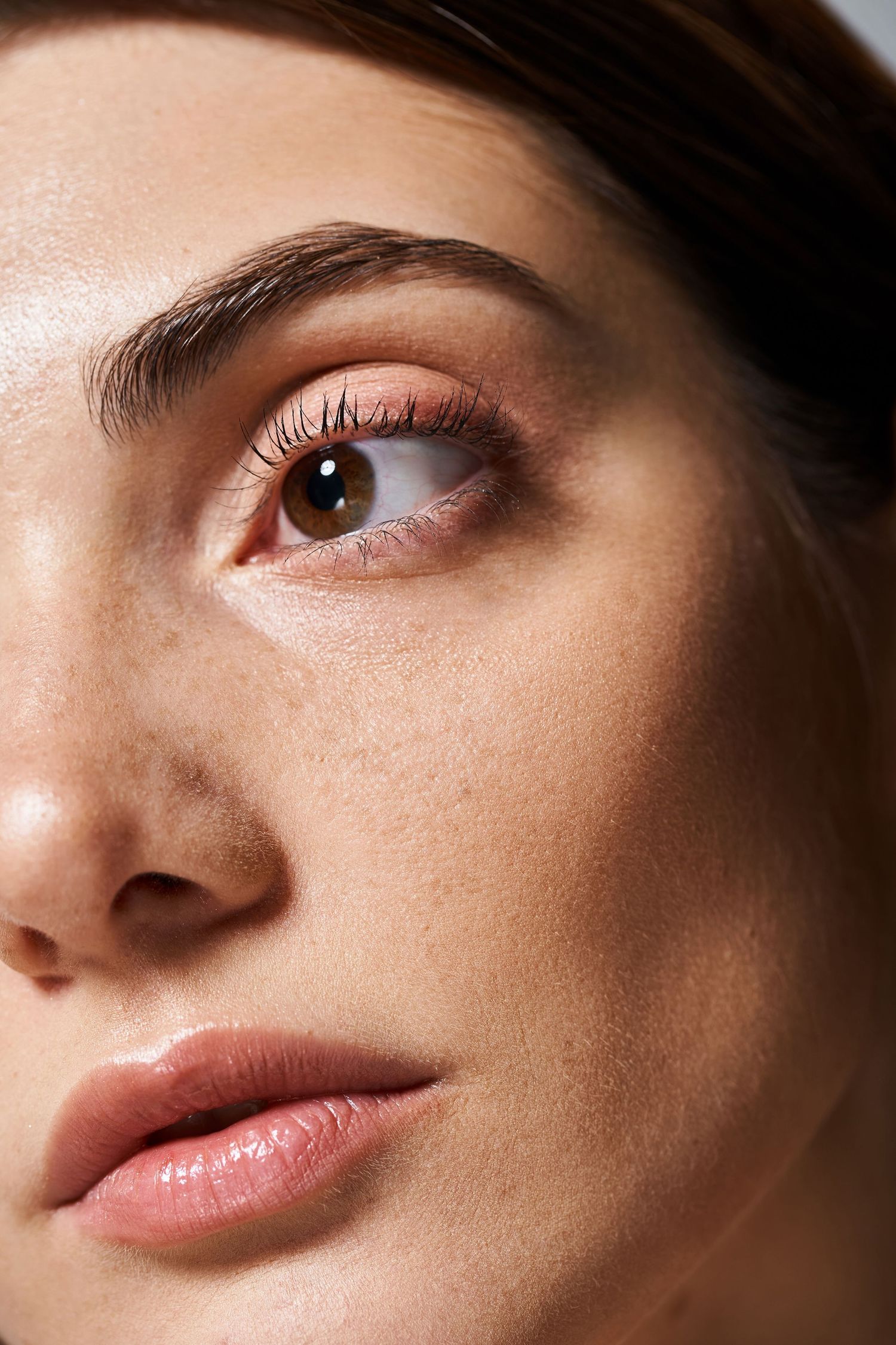 Close-up macro shots of facial features showing natural beauty makeup and flawless skin texture.